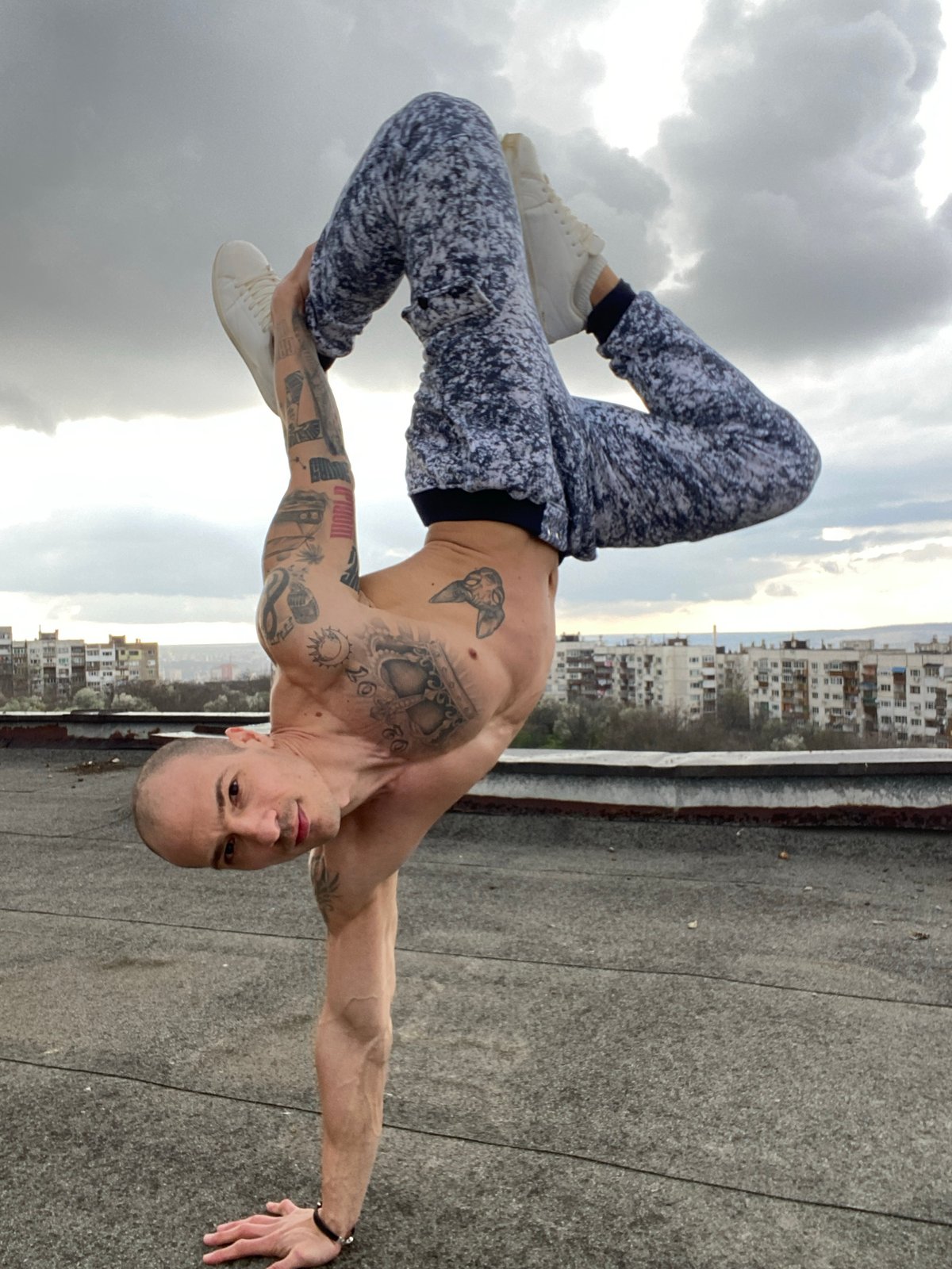Man performs rooftop workout amid dramatic skies in Pleven