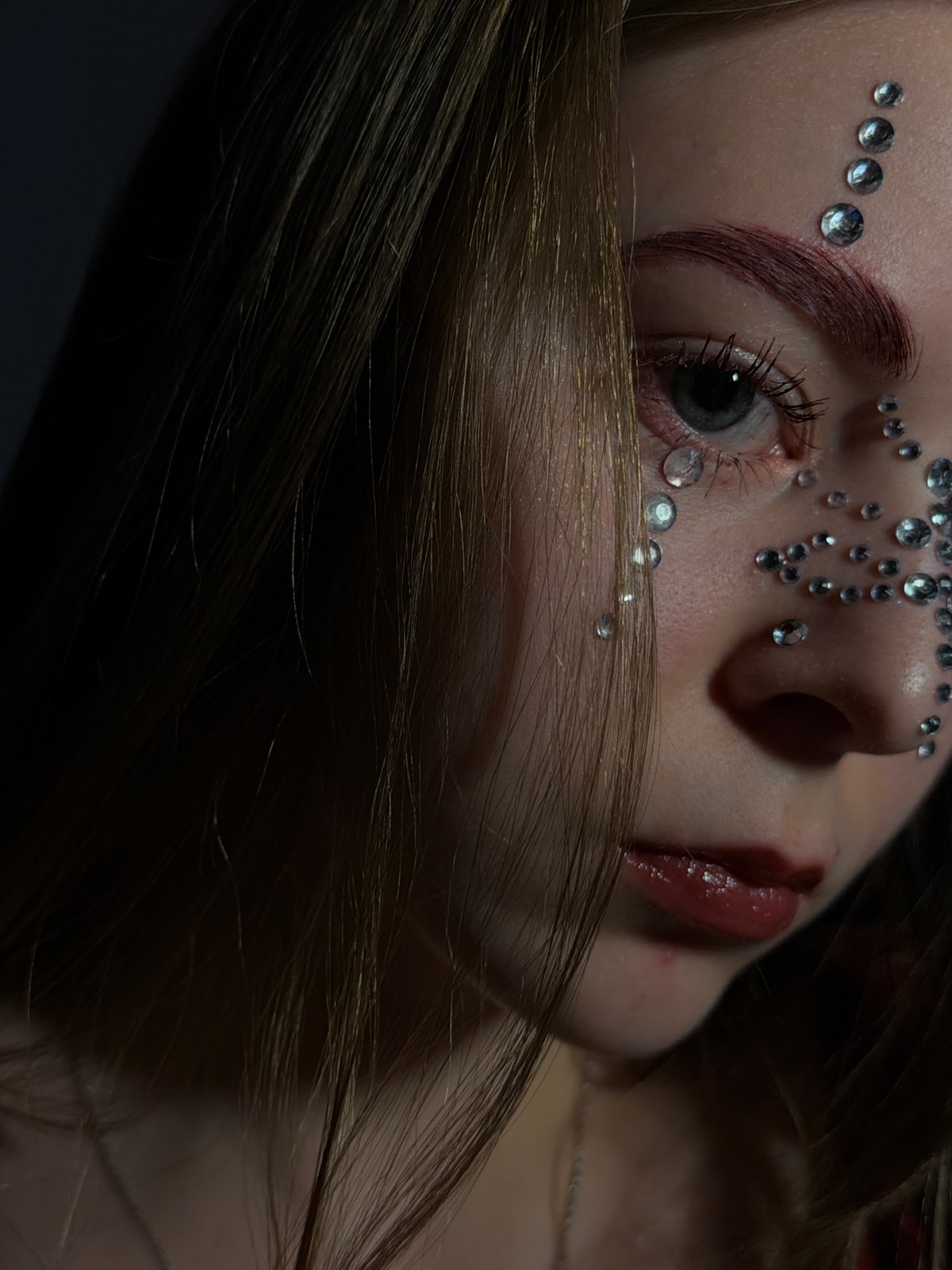 Person displays elaborate rhinestone face art in Perm, Russia