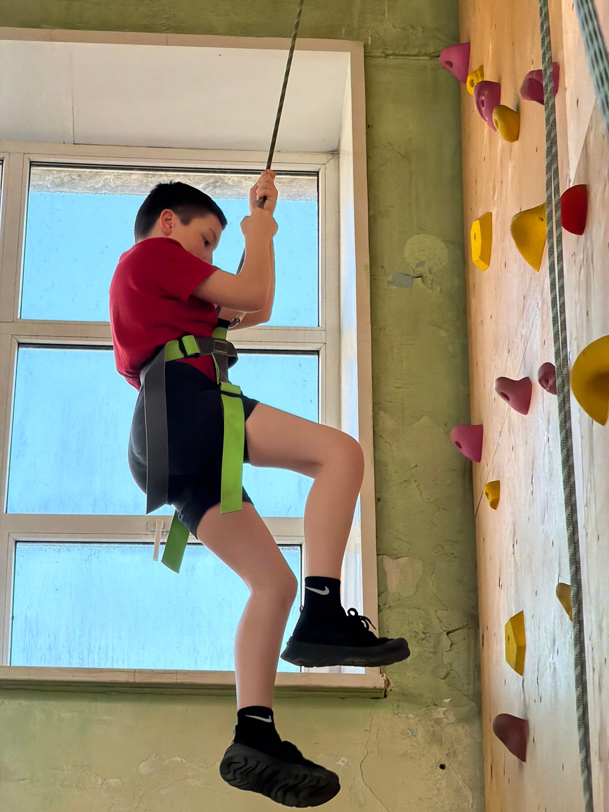 Young climber enjoys indoor rock climbing session in Izhevsk