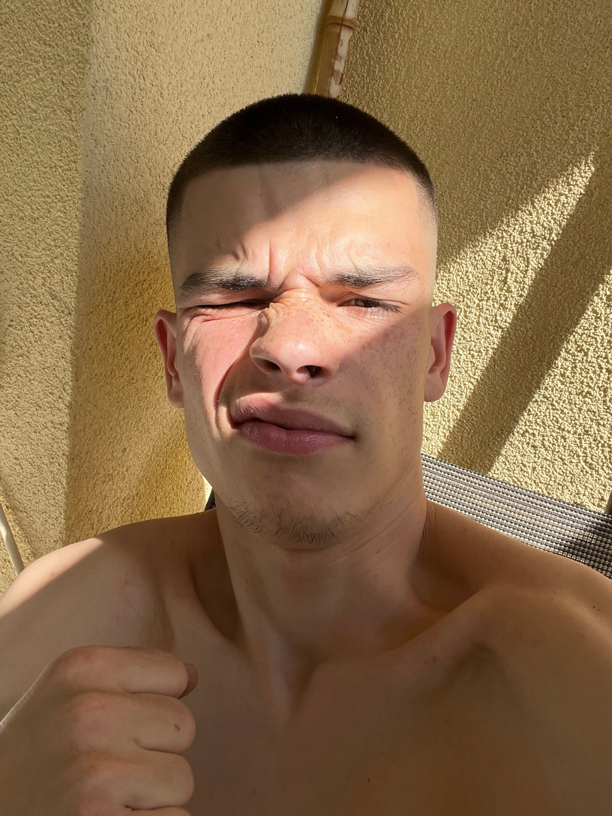 Man takes smoking selfies outside building in Sopot