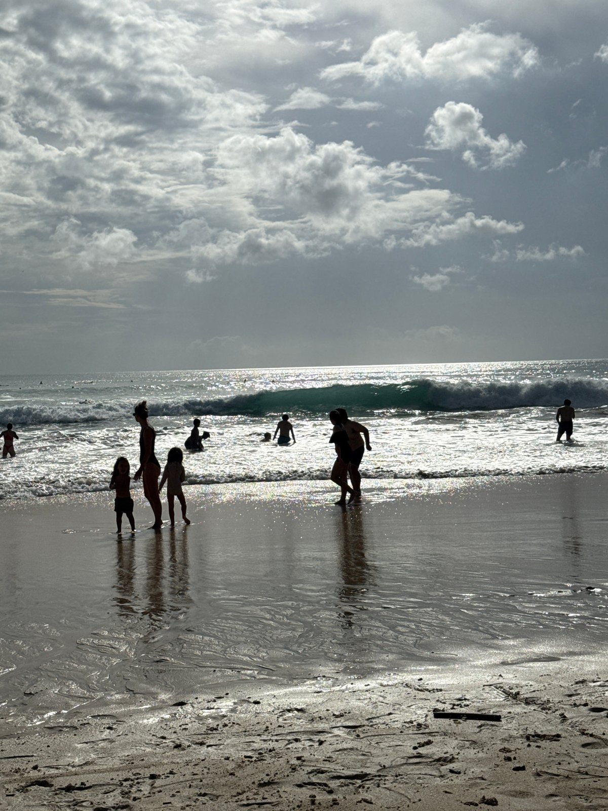 Woman and child enjoy morning beach time in Kuta