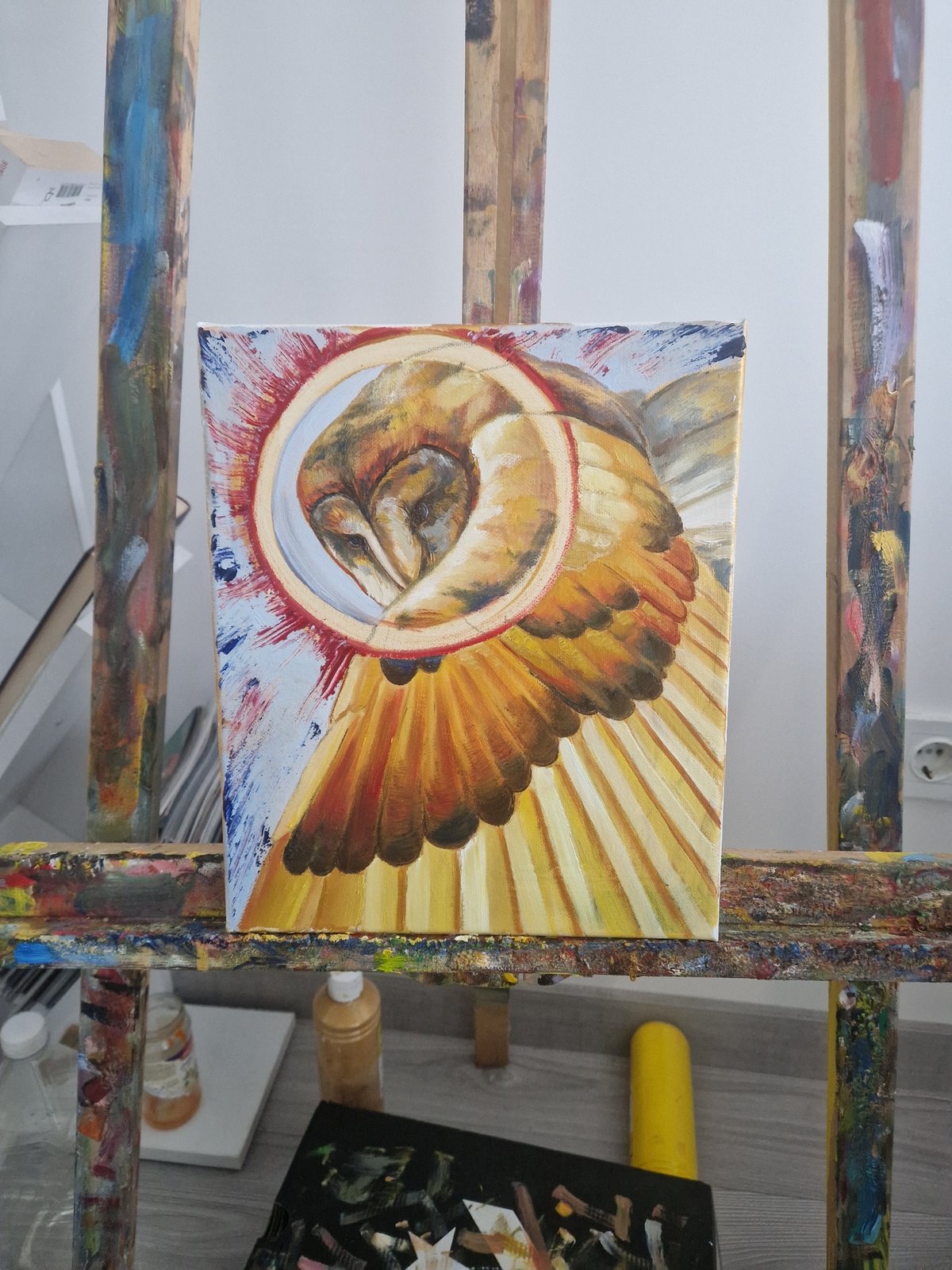 Art studio workspace documented with paint-splattered easel