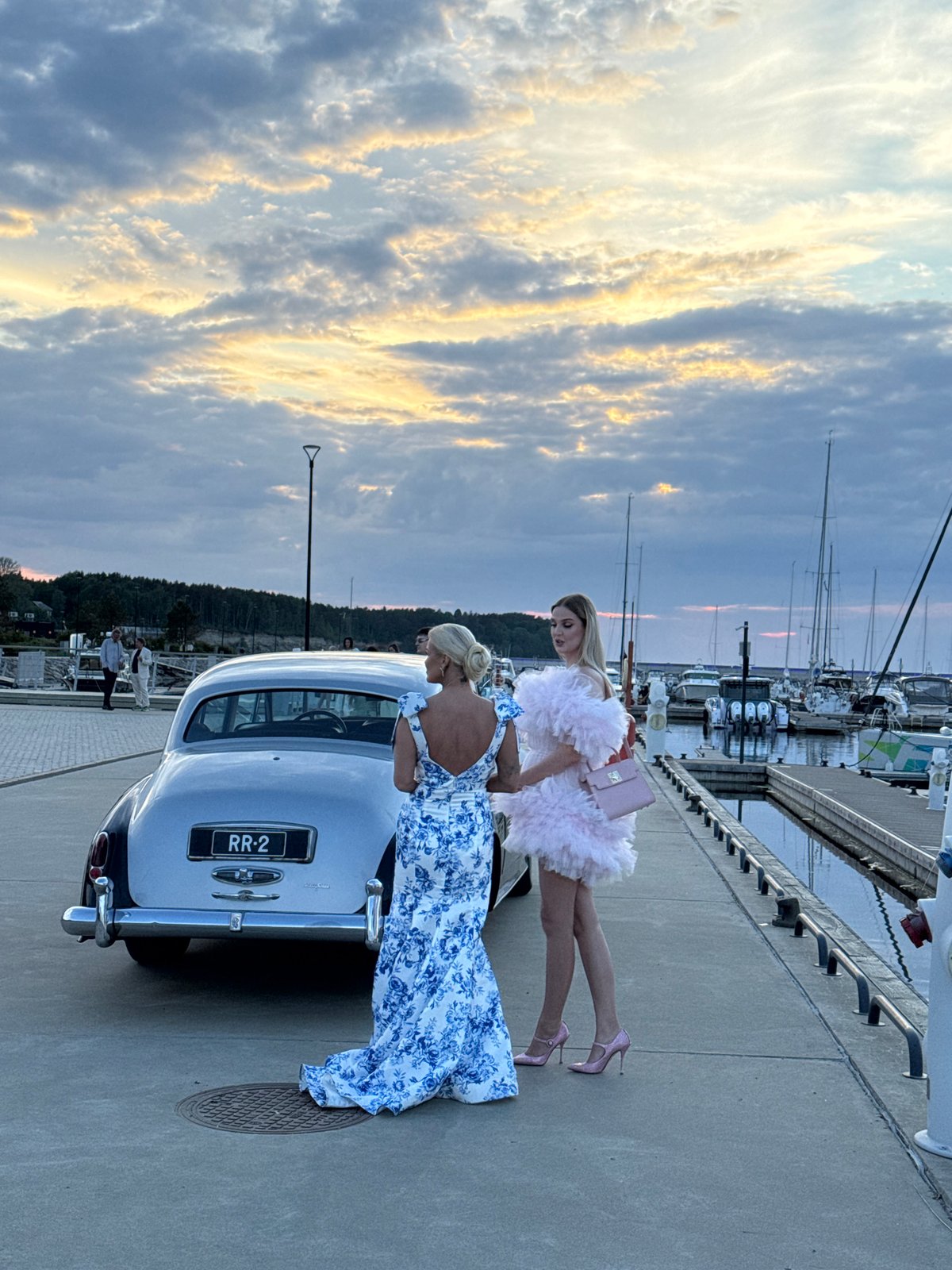 Luxury car gathering at Tallinn marina during golden hour