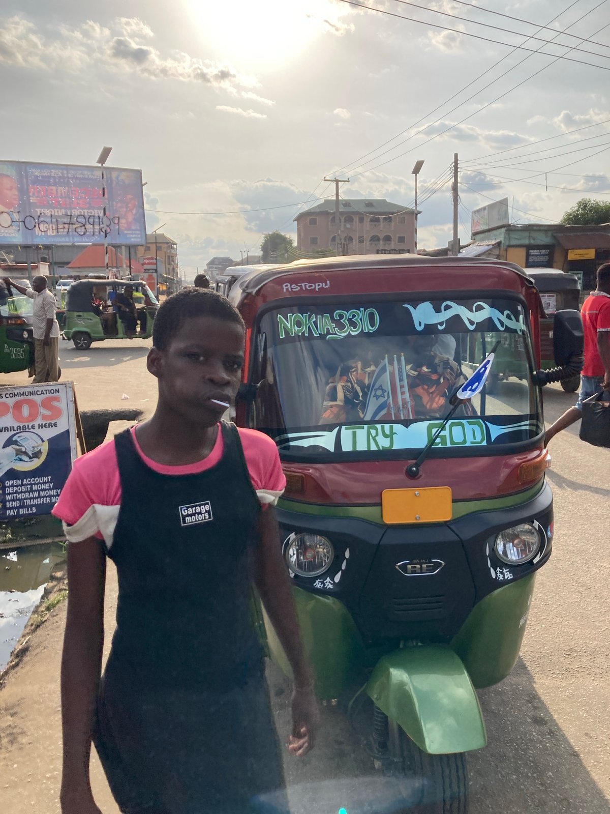 Person poses with decorated moto-taxi in Umuode, Nigeria