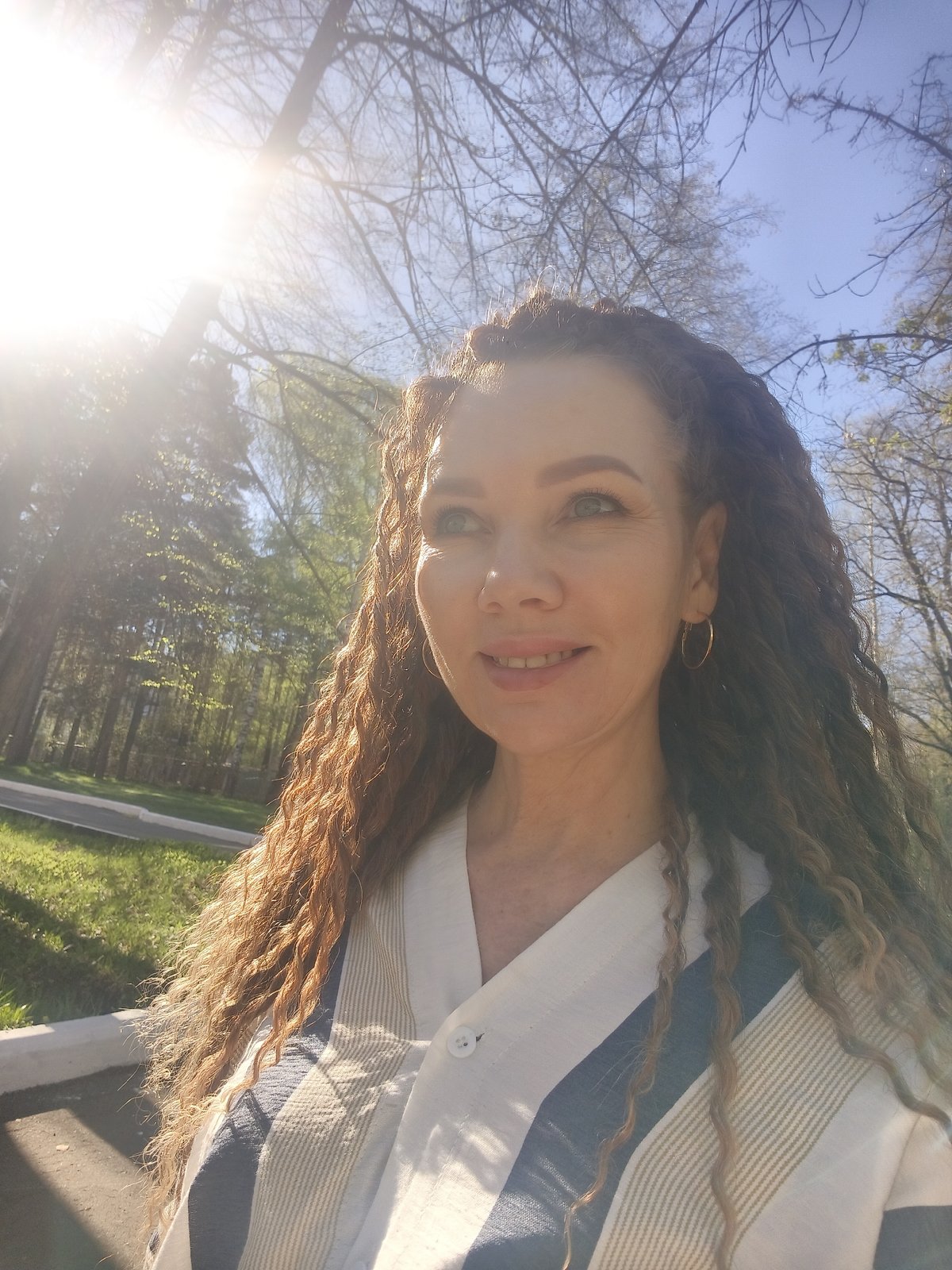 Woman spotted in sunny park near multi-story building