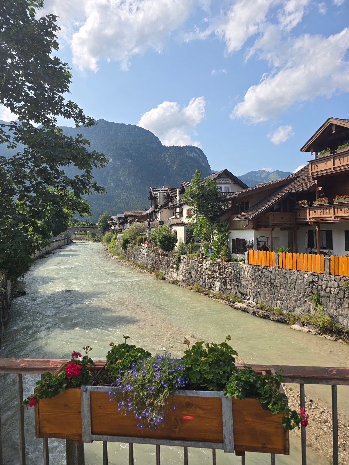 Loisach River and flower-lined streets of Garmisch-Partenkirchen in summer