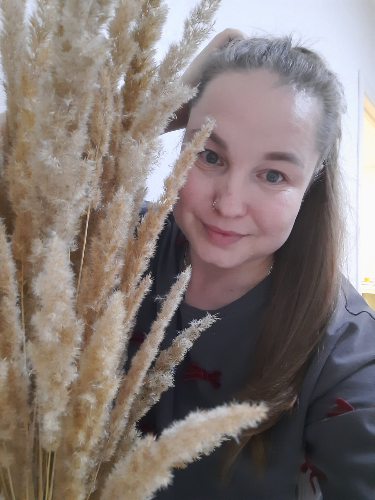 Woman photographed indoors with pampas grass in Pervomaysky