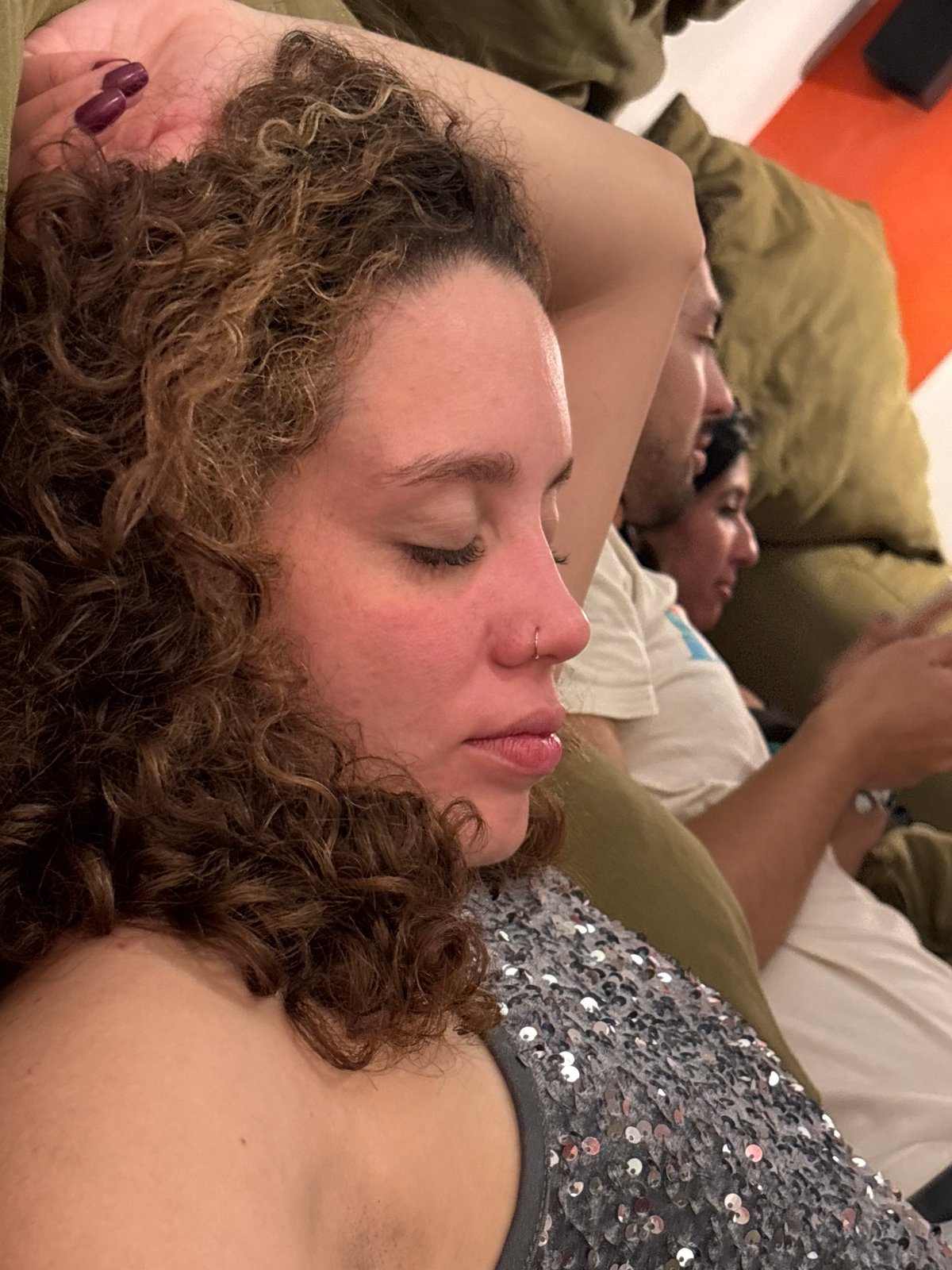 Three people relax on couch in early morning São Paulo