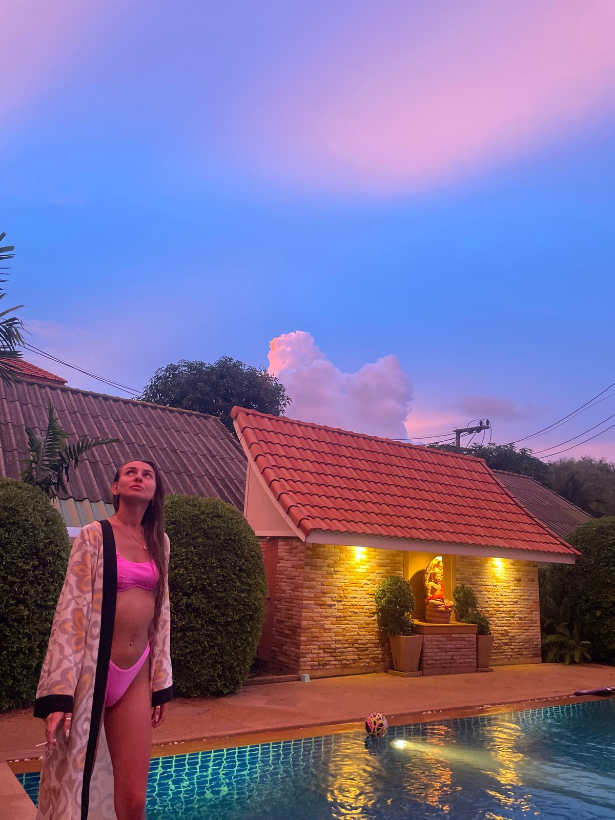 Rawai villa at dusk: poolside scenes and Hindu-Buddhist statuary