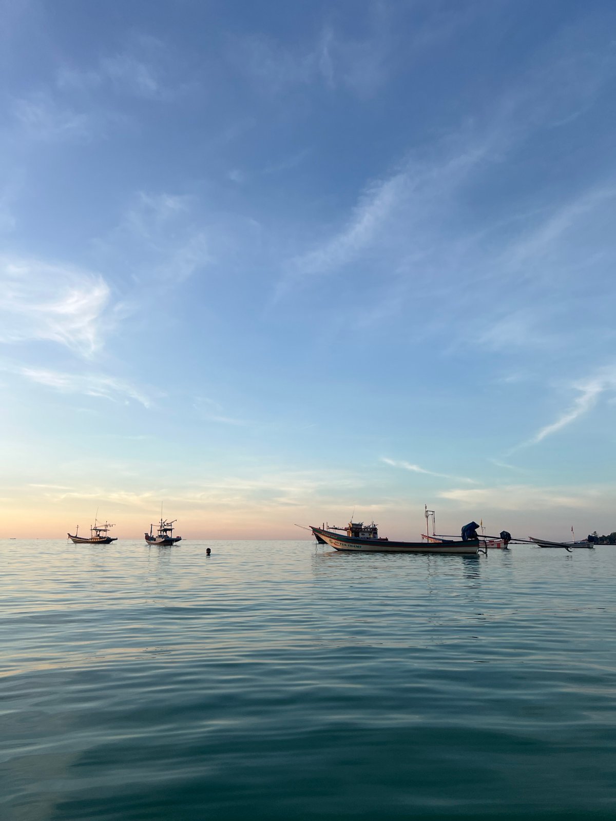 Sunset beach scenes and fishing boats on Koh Phangan