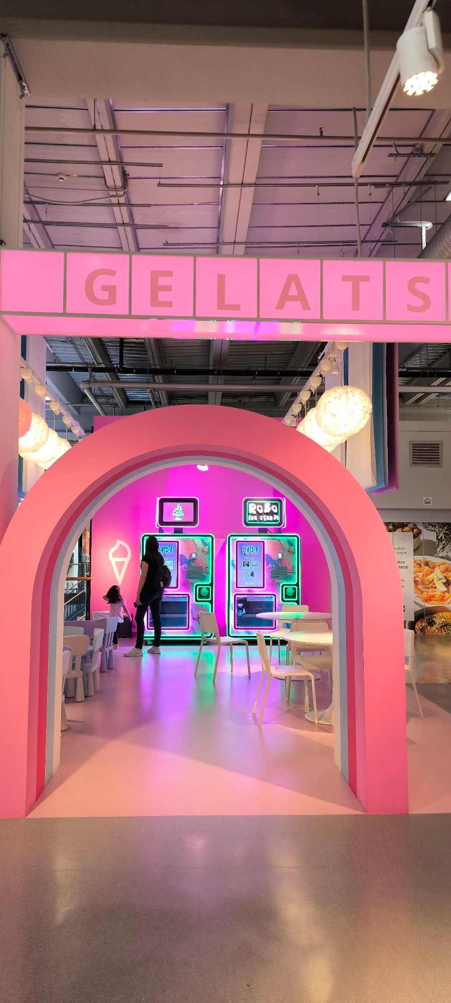 Shopper documents colorful retail store sections in Sabadell