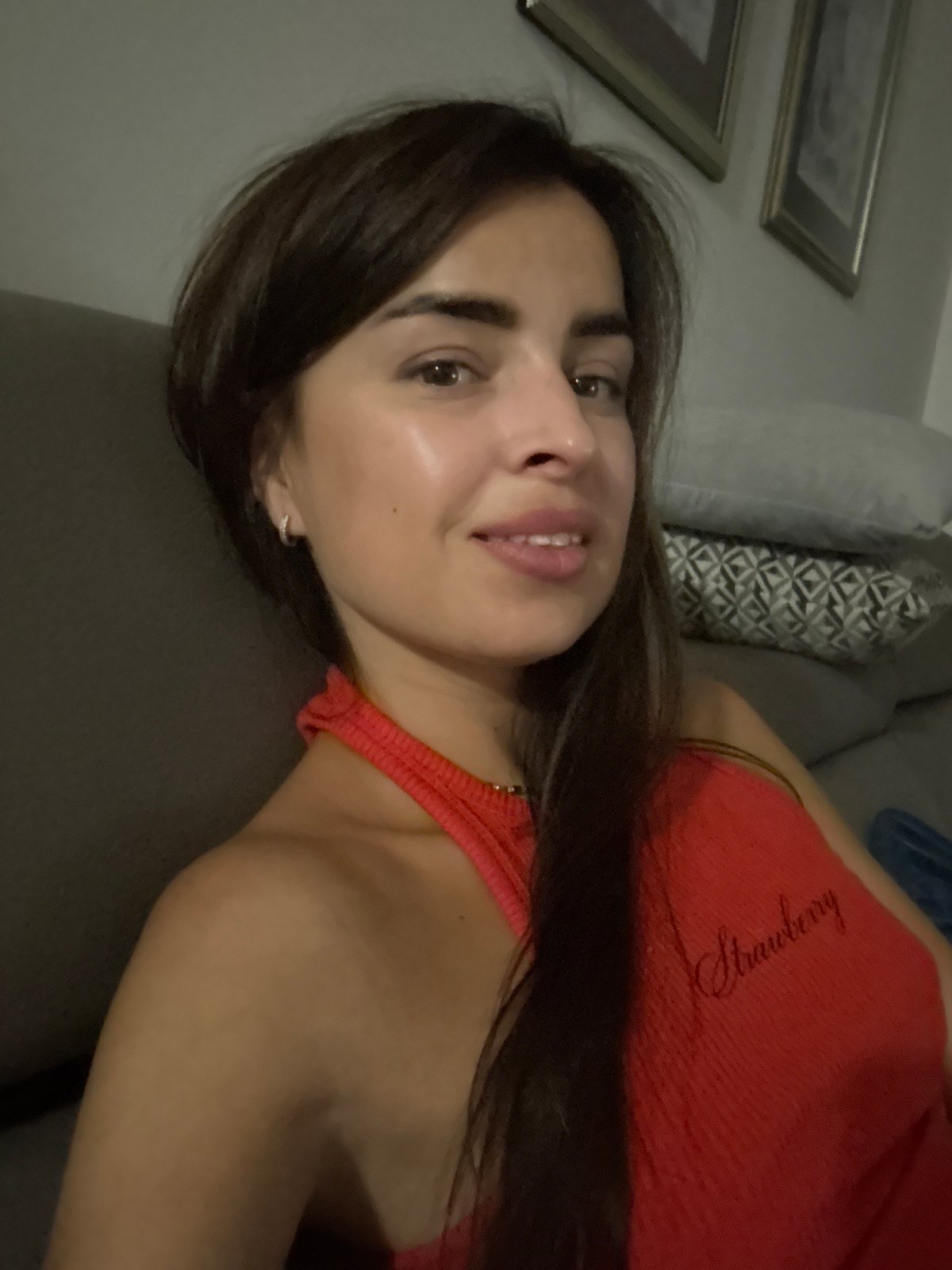 Indoor selfie session in a red Strawberry tank top