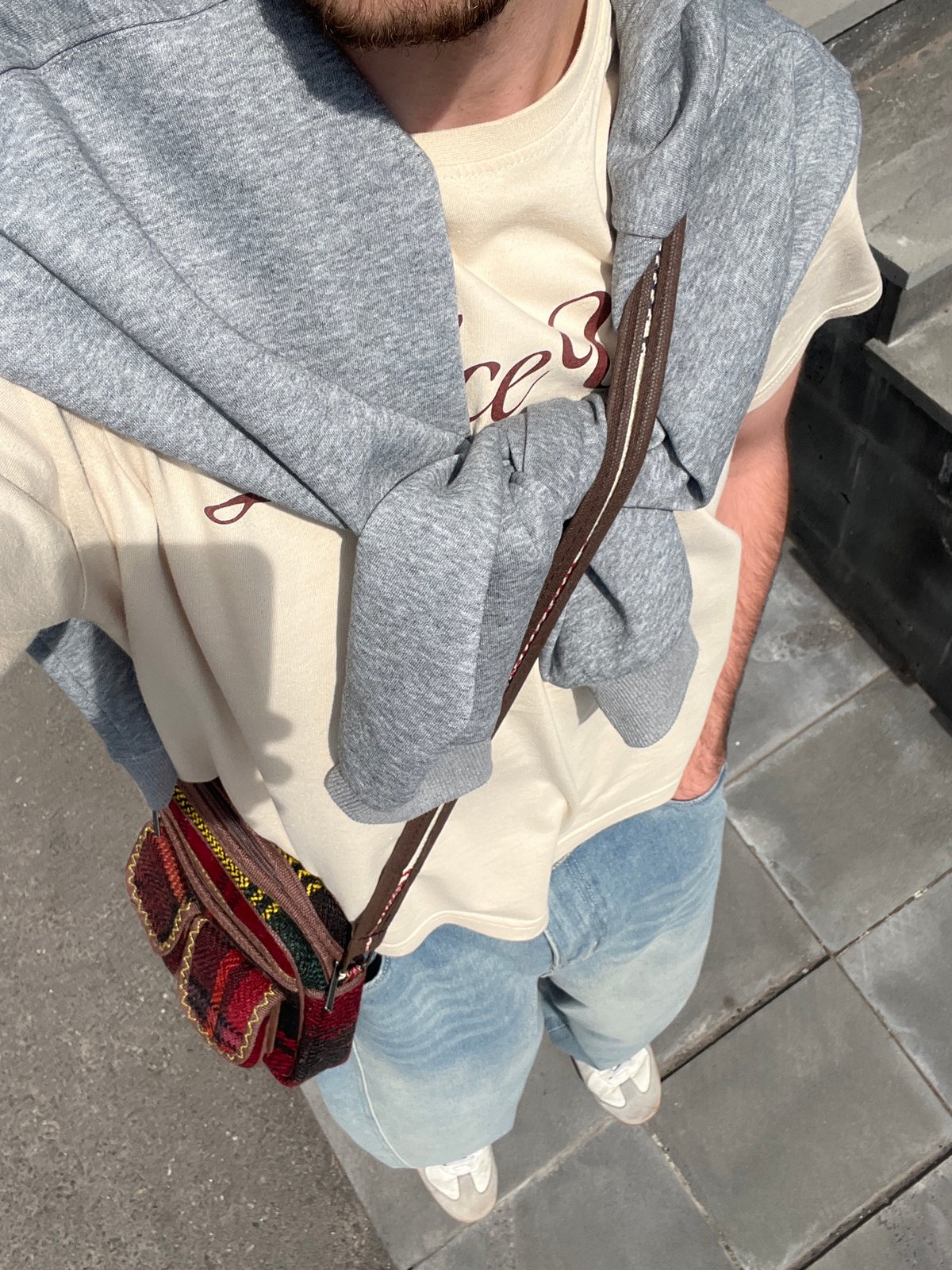 Person observed standing on Yerevan sidewalk in casual attire