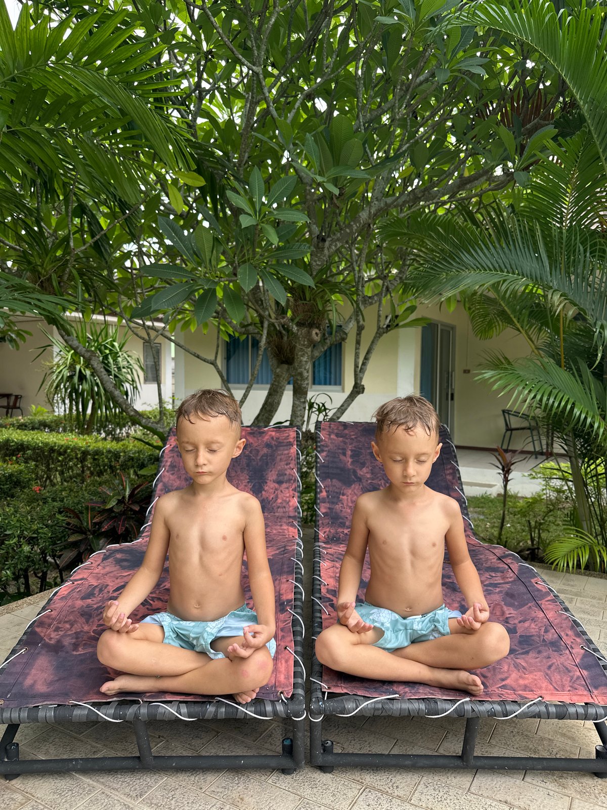 Kids meditating on an outdoor lounge chair in Ko Samui