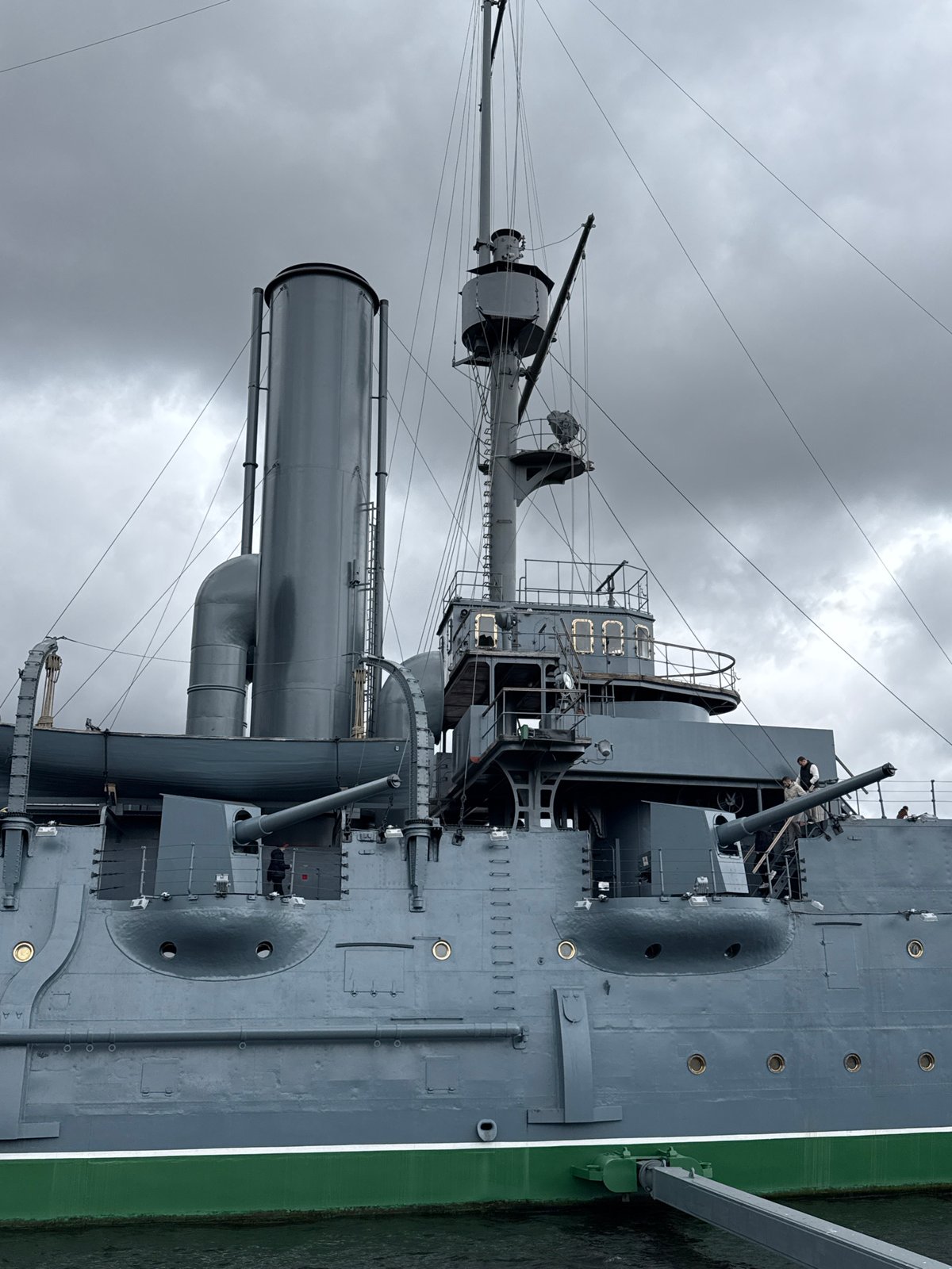 Tourists document historic Aurora cruiser museum ship in Saint Petersburg