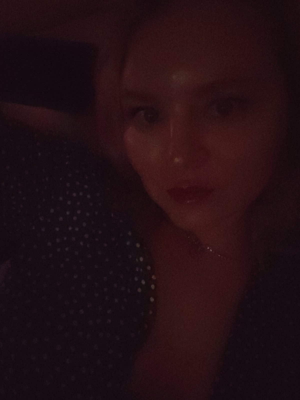 Woman enjoys private movie night with wine in Izhevsk bedroom