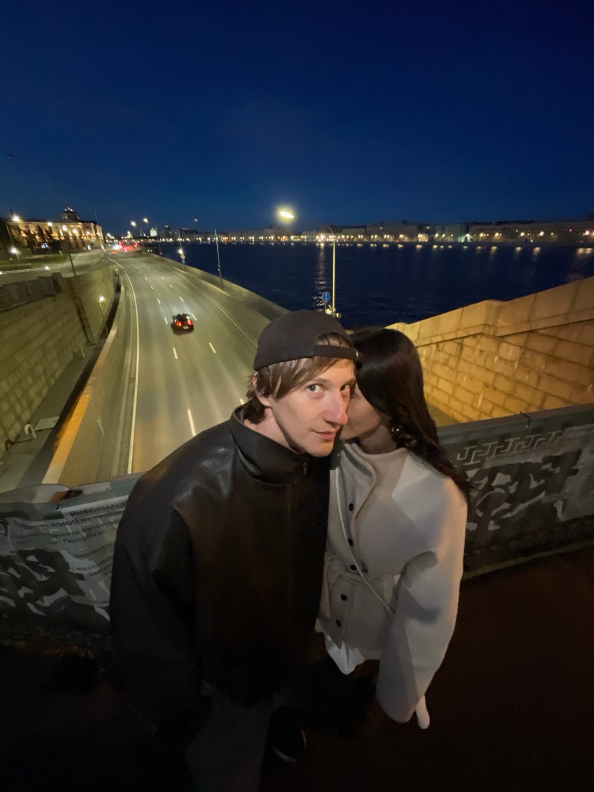 Couple photographed on bridge in Saint Petersburg at night