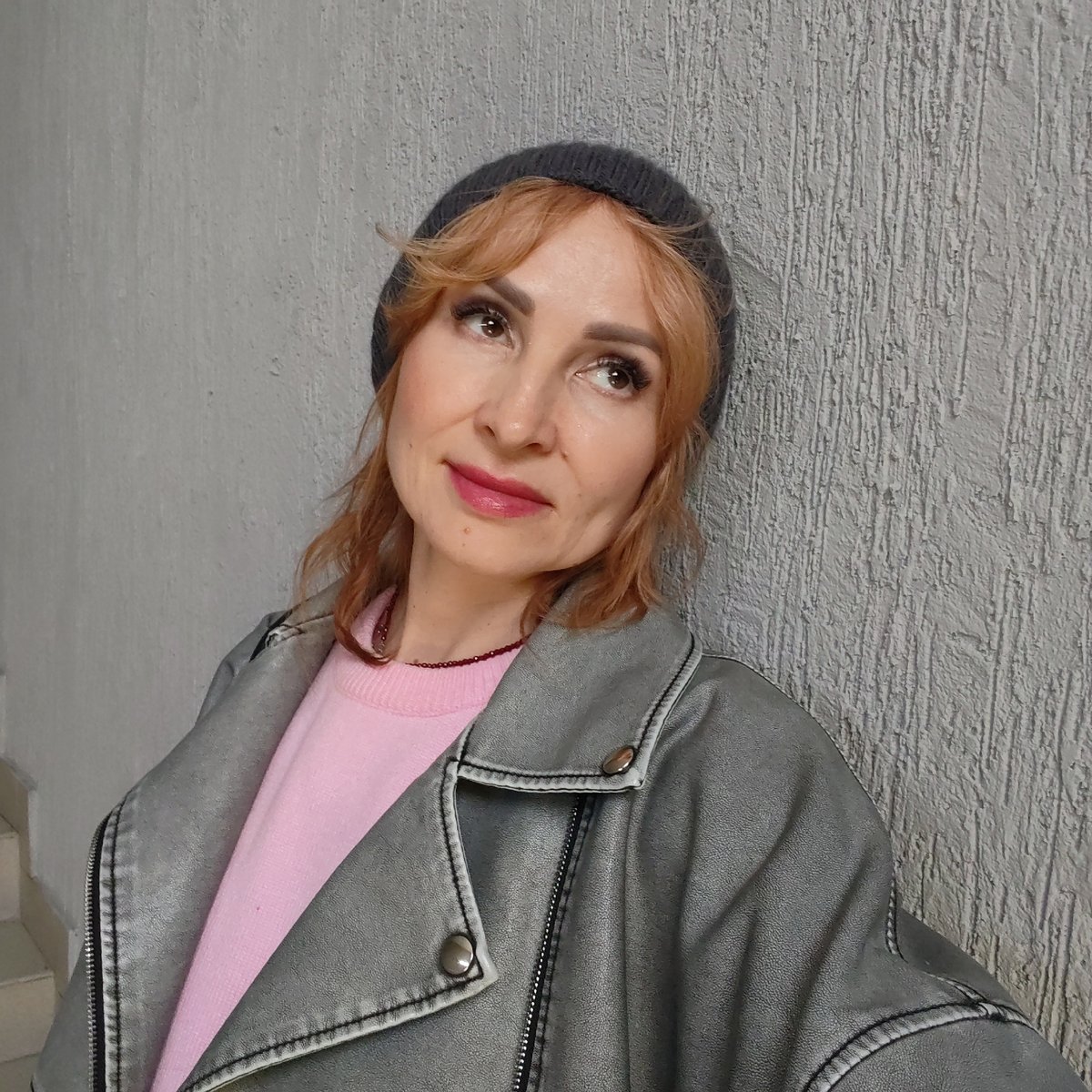 Woman photographs herself near construction vehicles in Chaikovsky