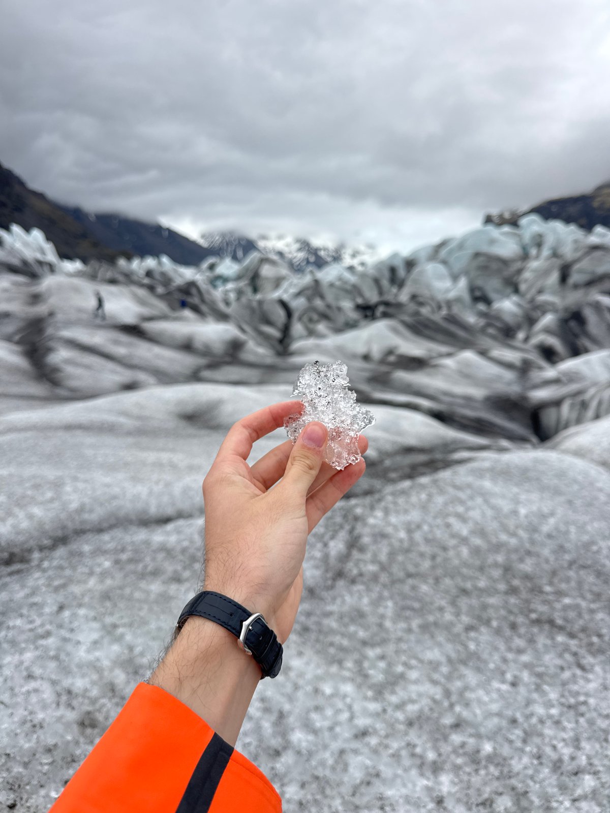 Tourists document glacier visit in Iceland during afternoon excursion