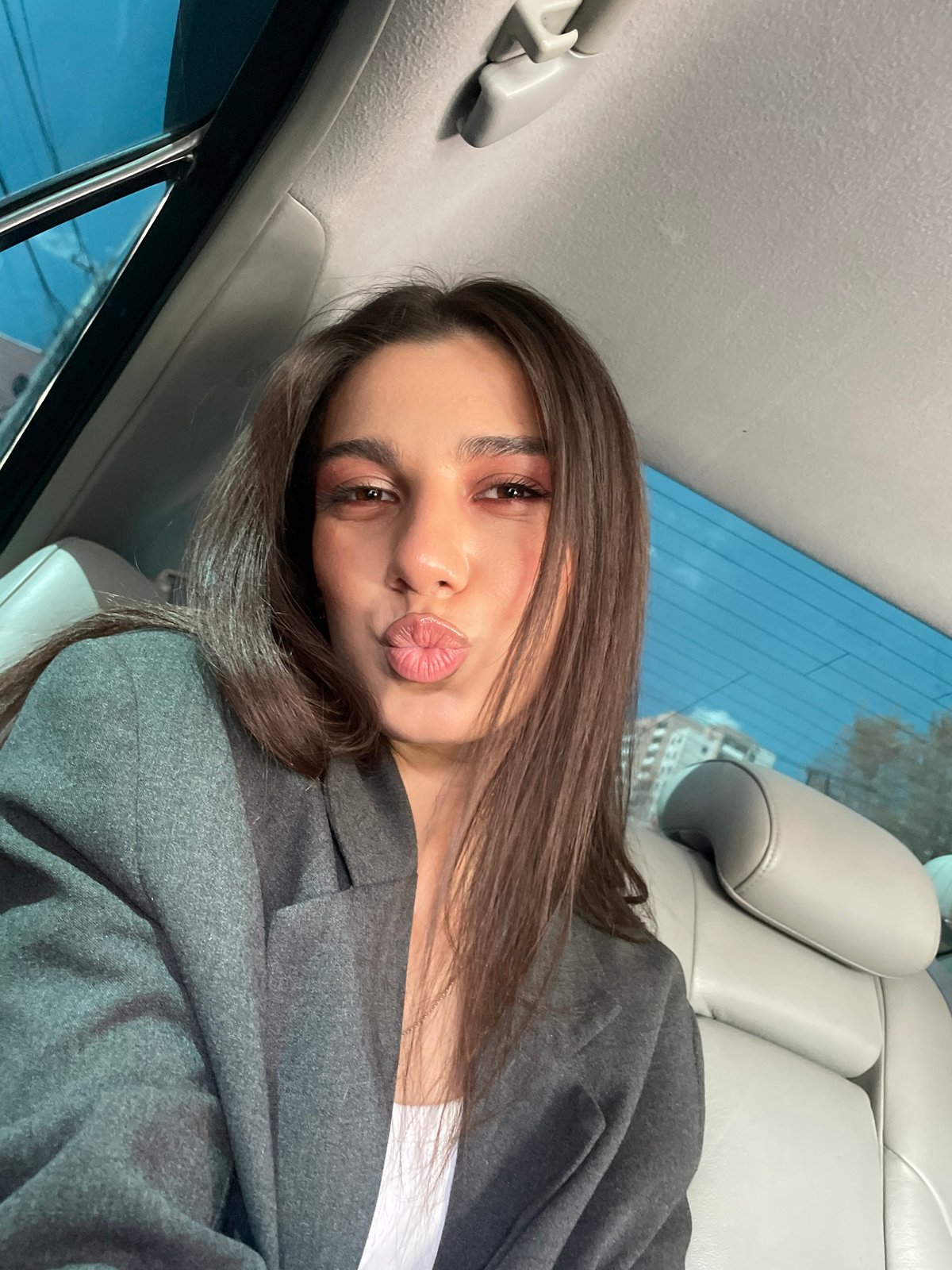 Woman takes selfie in car backseat in Yerevan