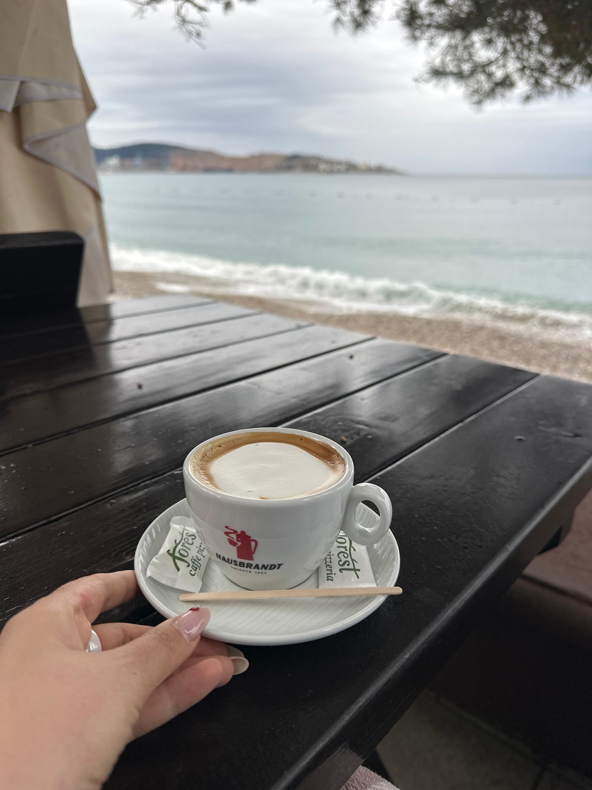 Morning coffee captured at Šušanj beachside cafe overlooking Adriatic