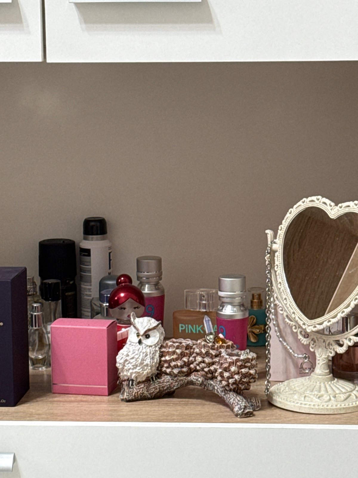 Interior home spaces documented showing decorative shelf and electrical outlet