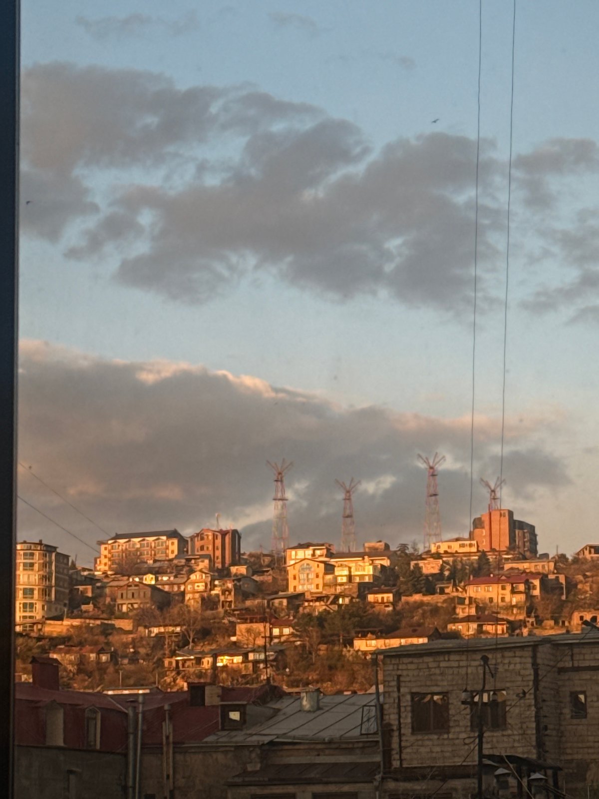 Yerevan hillside residential buildings observed under cloudy skies