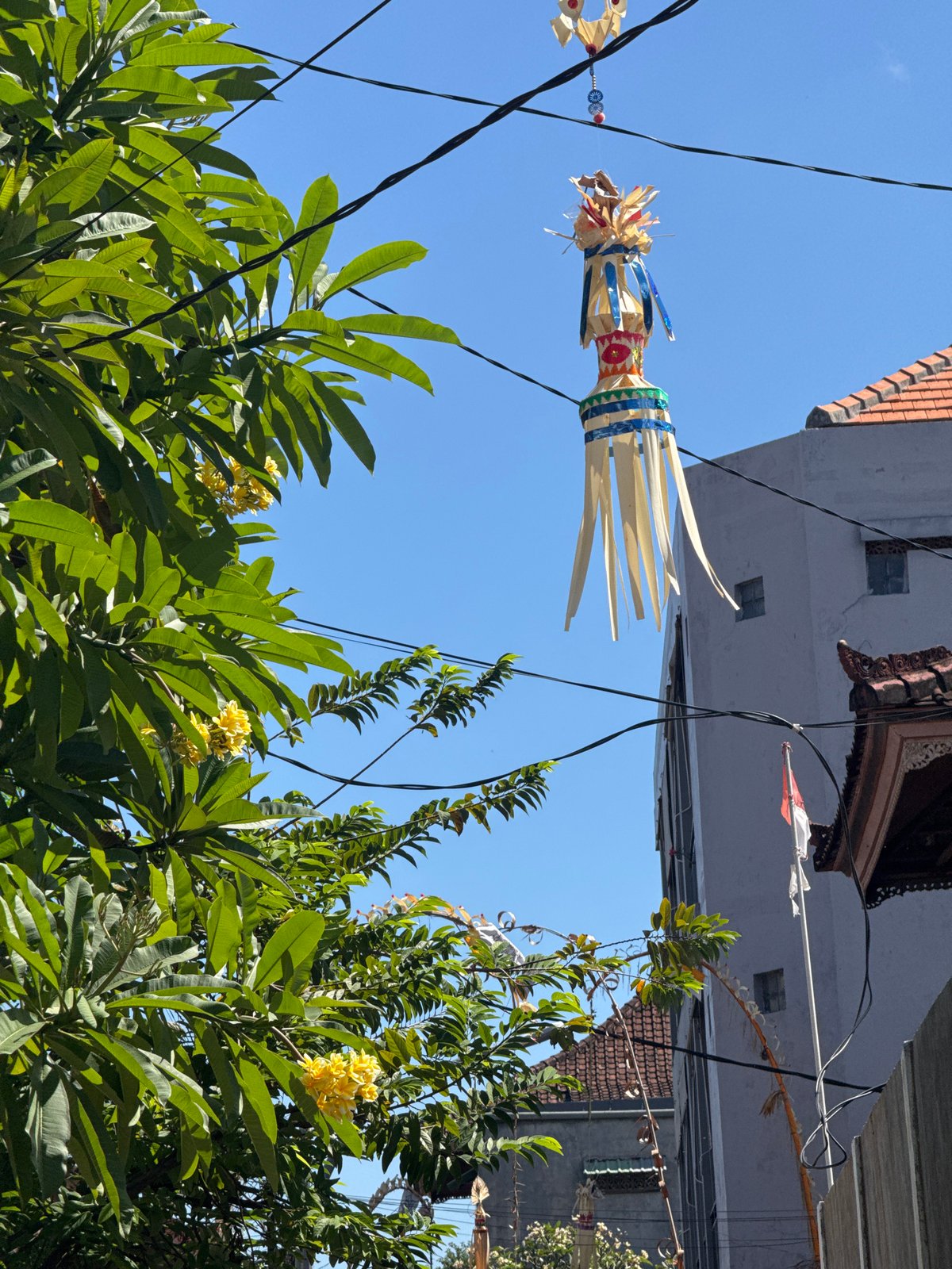 Kuta Beach and Balinese street details on a sunny morning