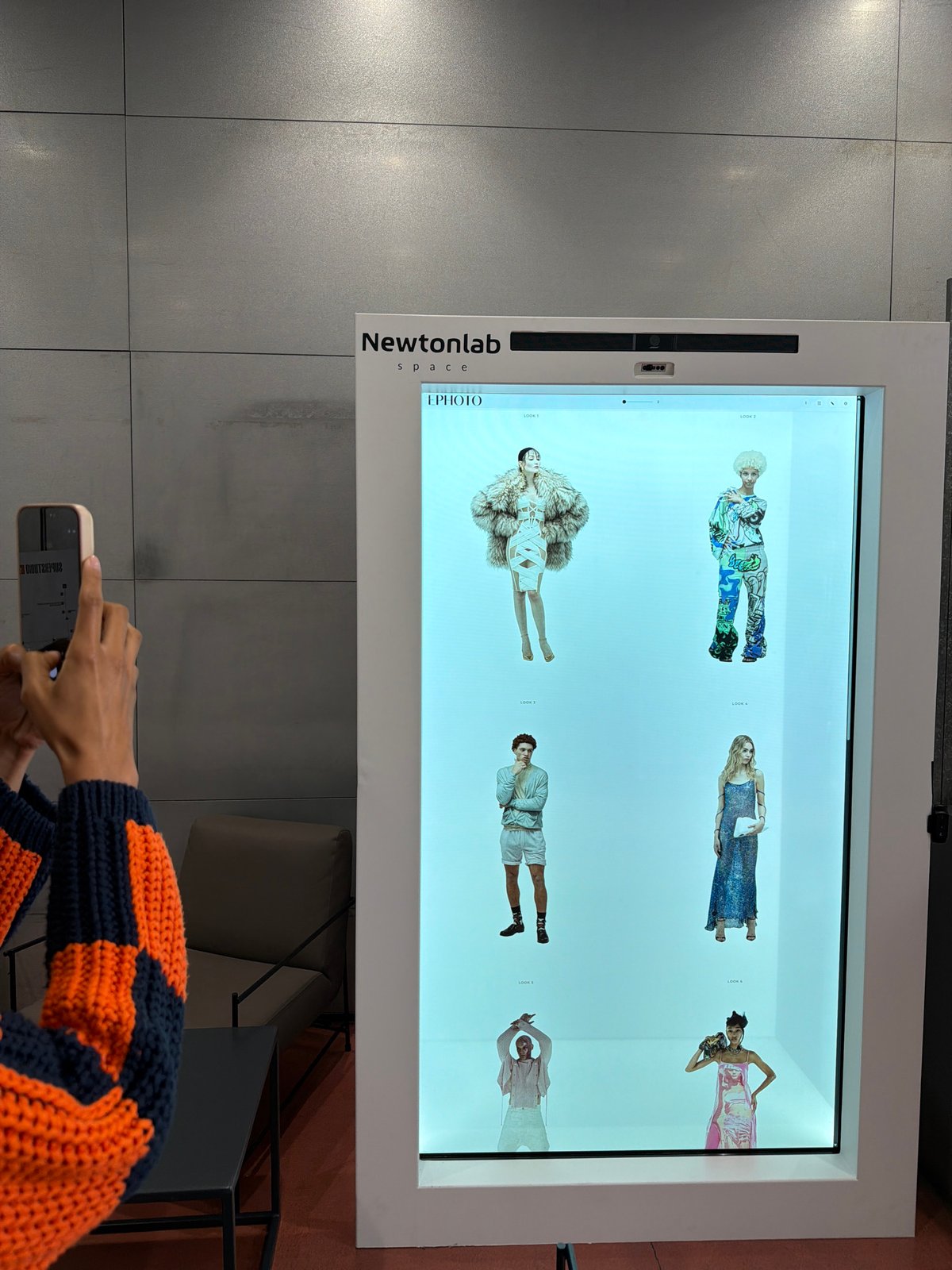 People interact with digital fashion displays in Milan