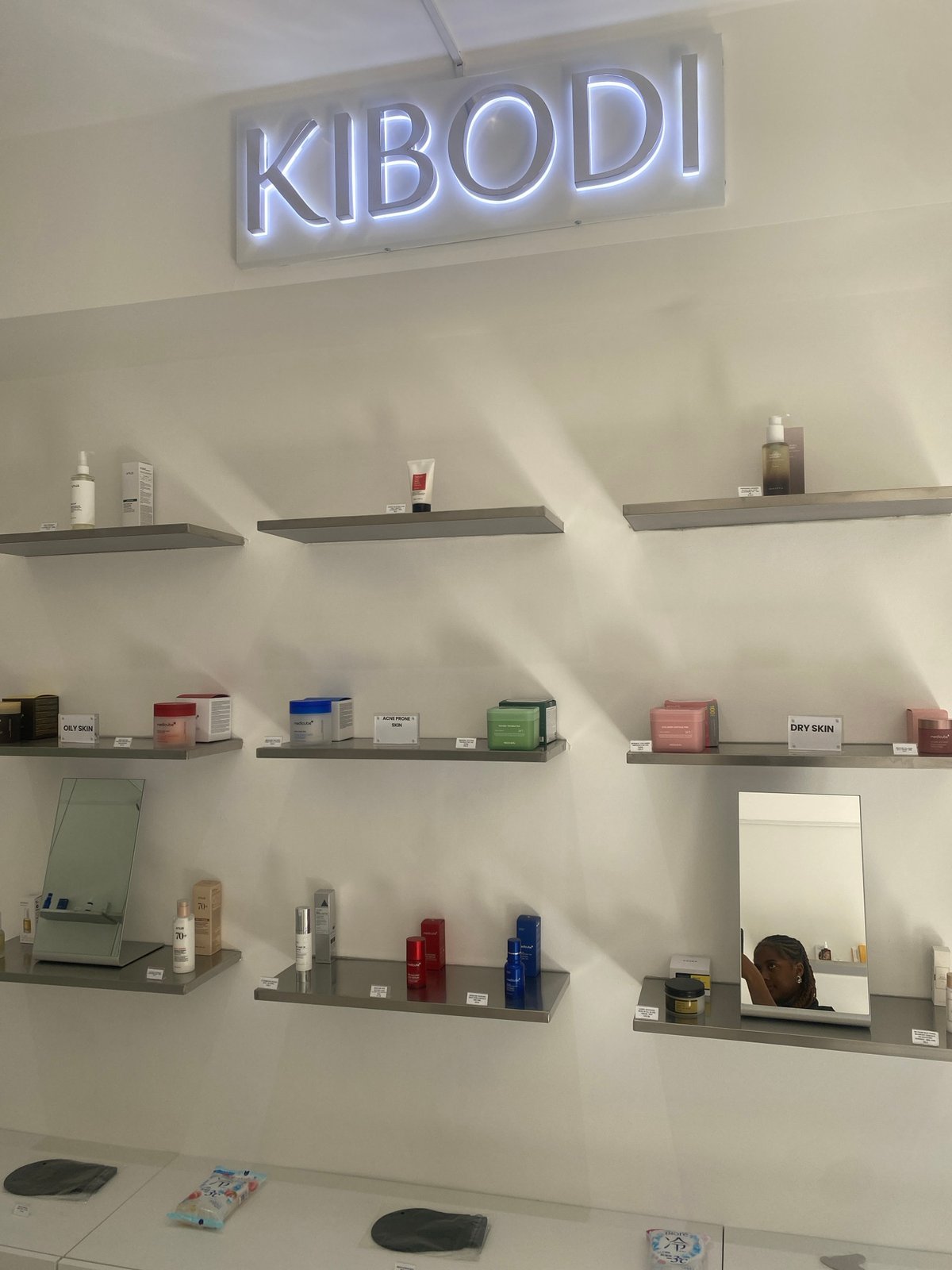 Customer browses cosmetics at London beauty store, displays colorful nail art