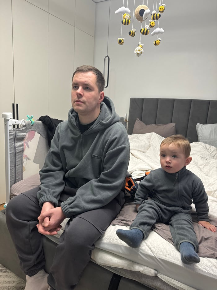 Father and child share quiet moment on bed in Odintsovo
