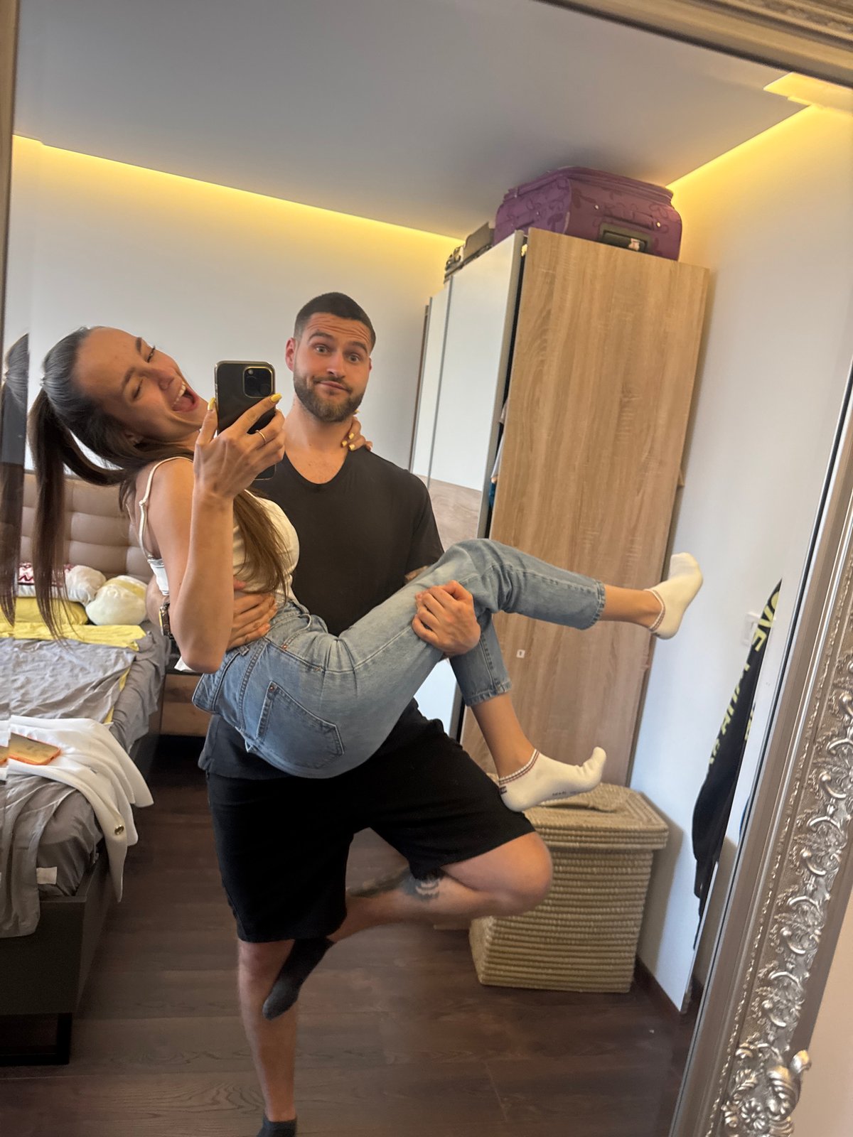 Couple Takes Multiple Selfies in Sofia Bedroom