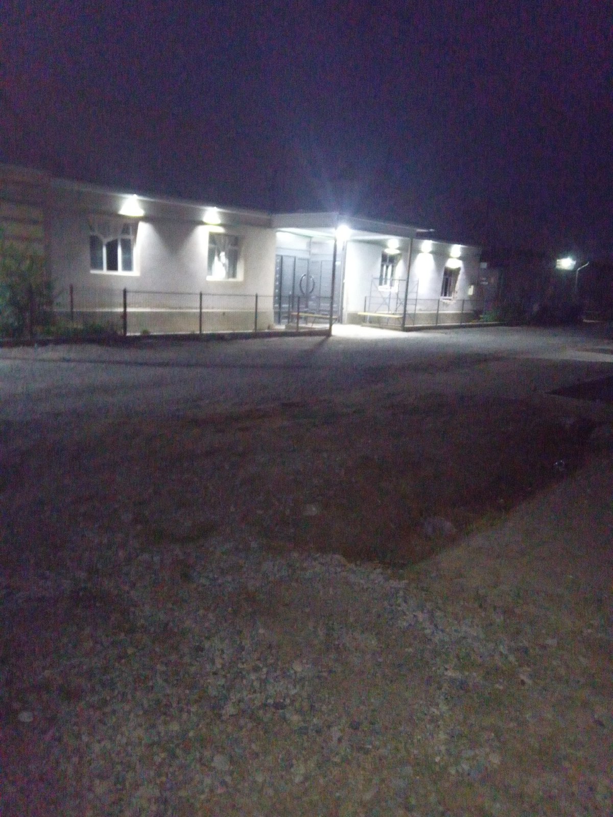 Dusk to nightfall: sky, streets, and a lit building