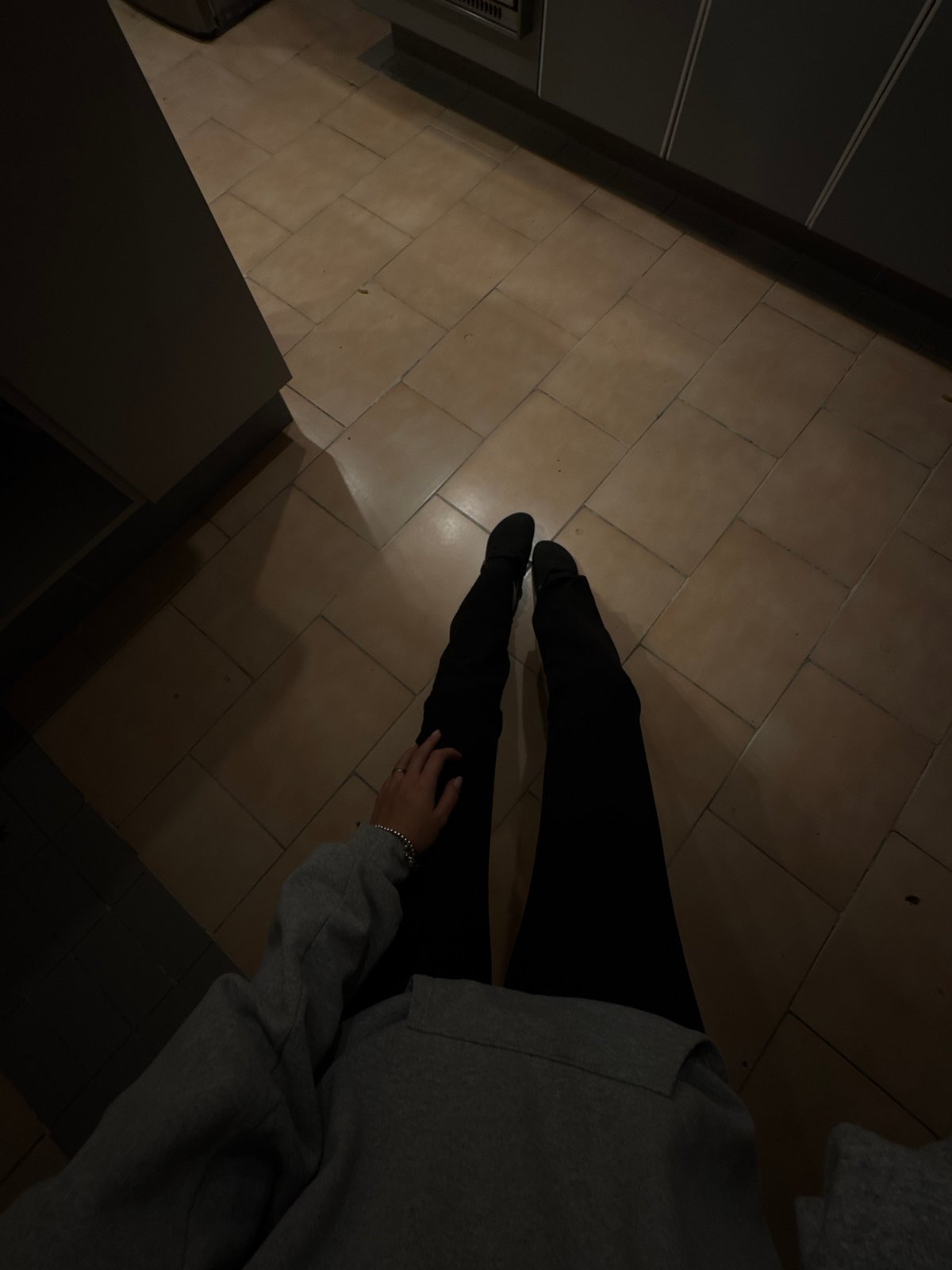 Person sits on kitchen floor in Mexico City home