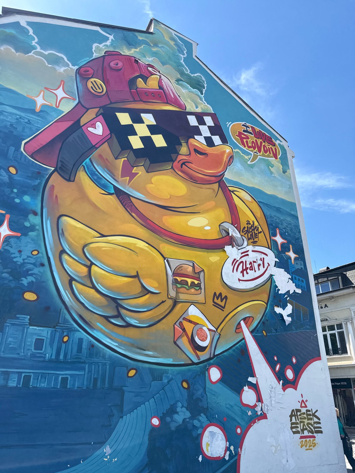 Yellow duck mural with pixelated design spotted on building