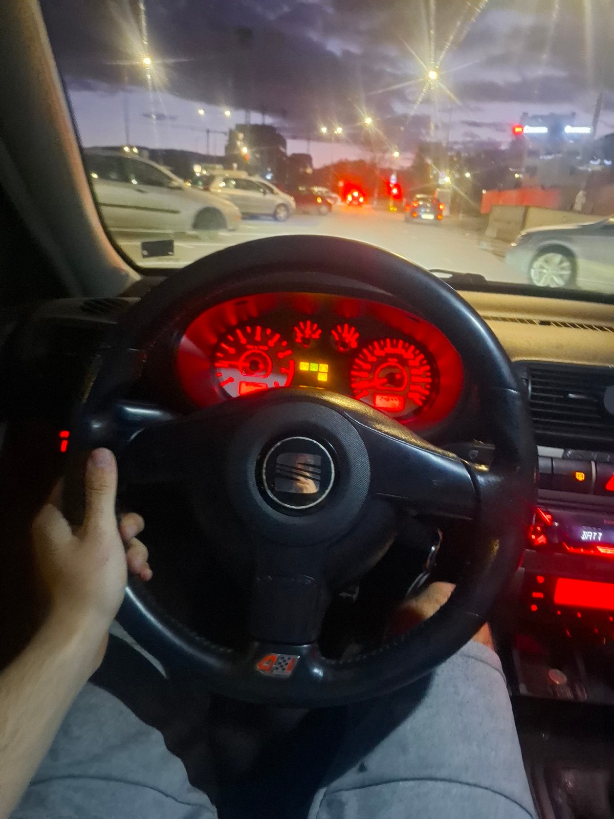 Driver photographed red-lit car interior in Sofia evening