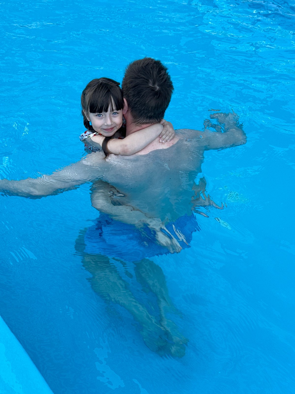 Father and daughter enjoy morning swim in Sochi pool