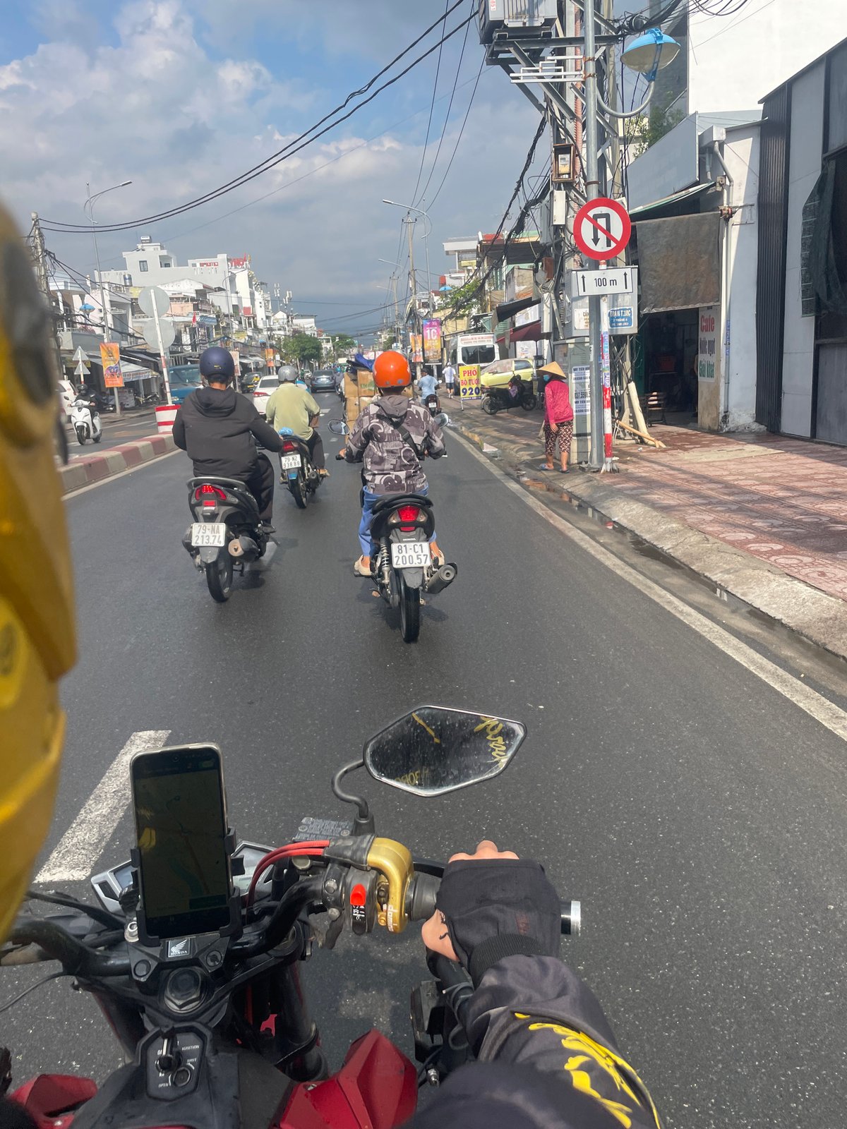 Motorbike traffic navigates wet streets in Nha Trang