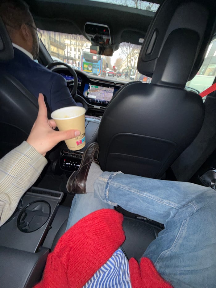 Suited driver observed from passenger seat in Paris