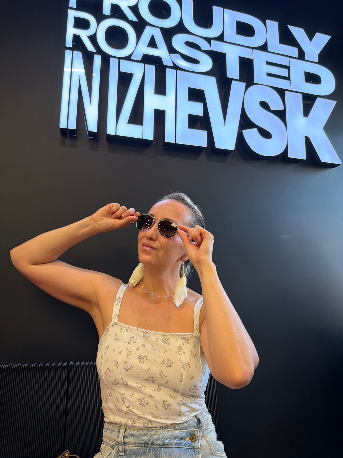 Posing at an Izhevsk roastery with illuminated signage
