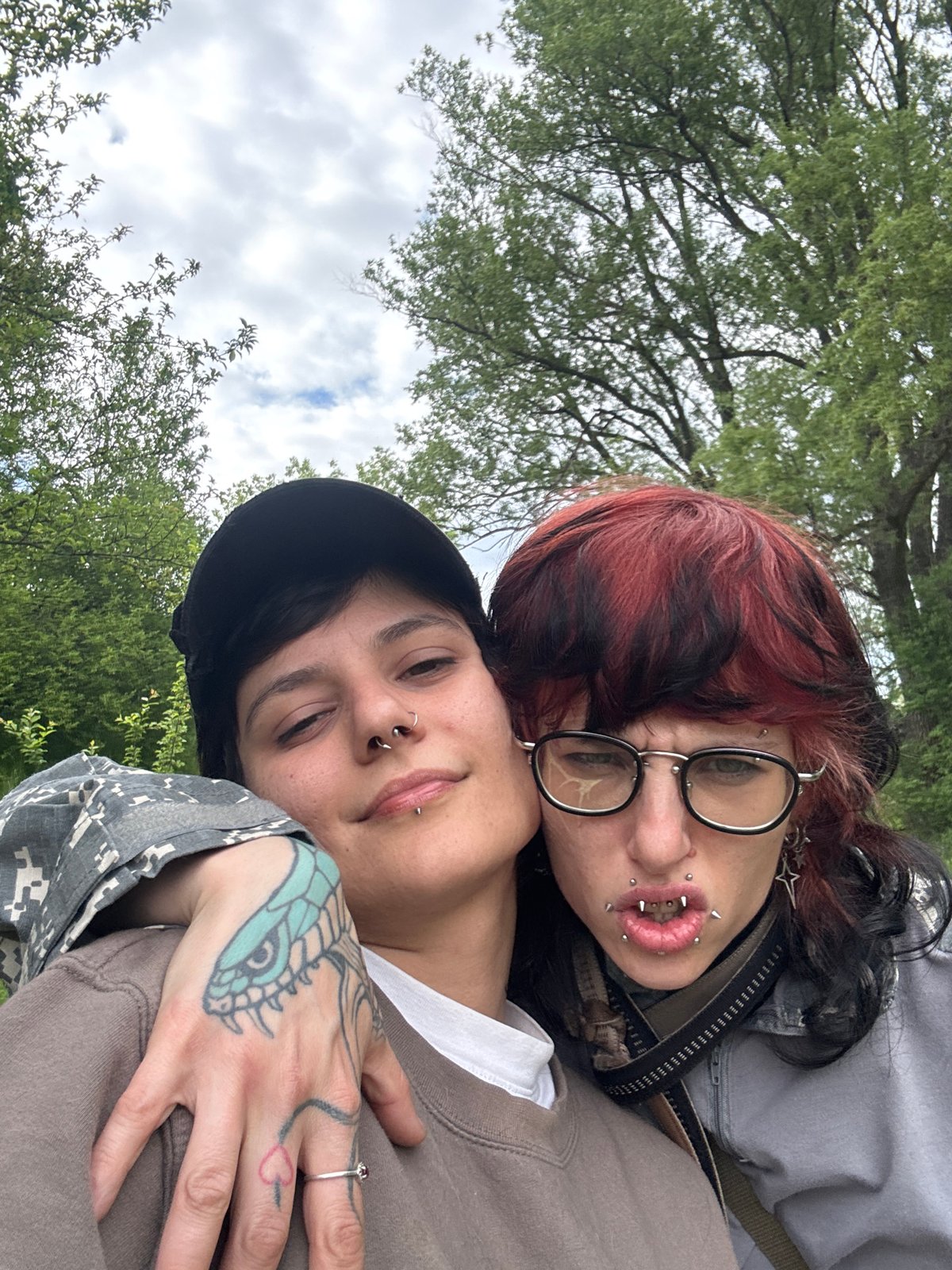 Two people photograph near Sofia church in grassy field