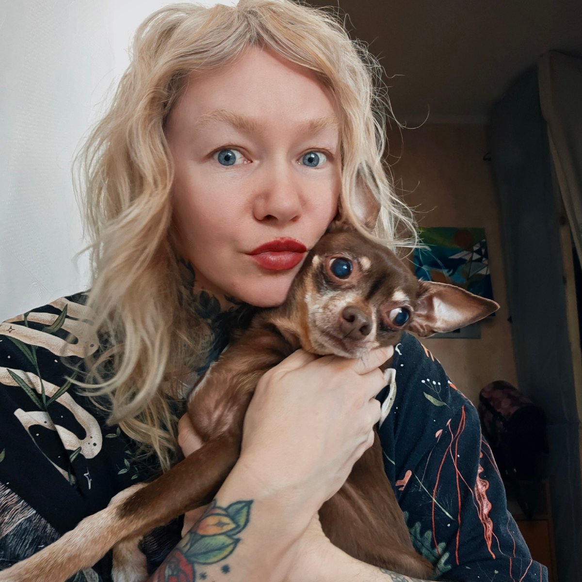 Woman poses with chihuahua in morning portrait session