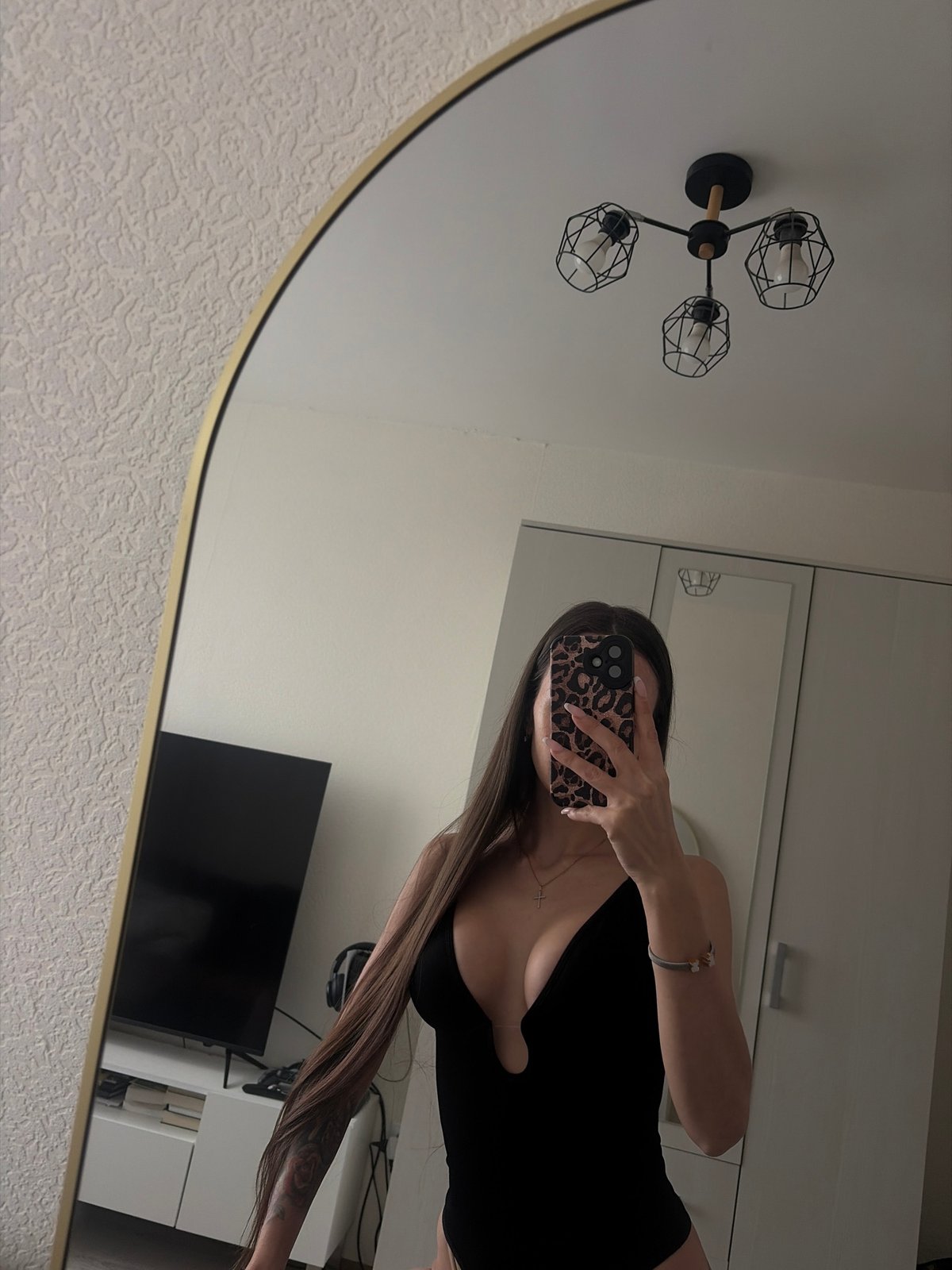 Woman takes selfie with leopard print phone case