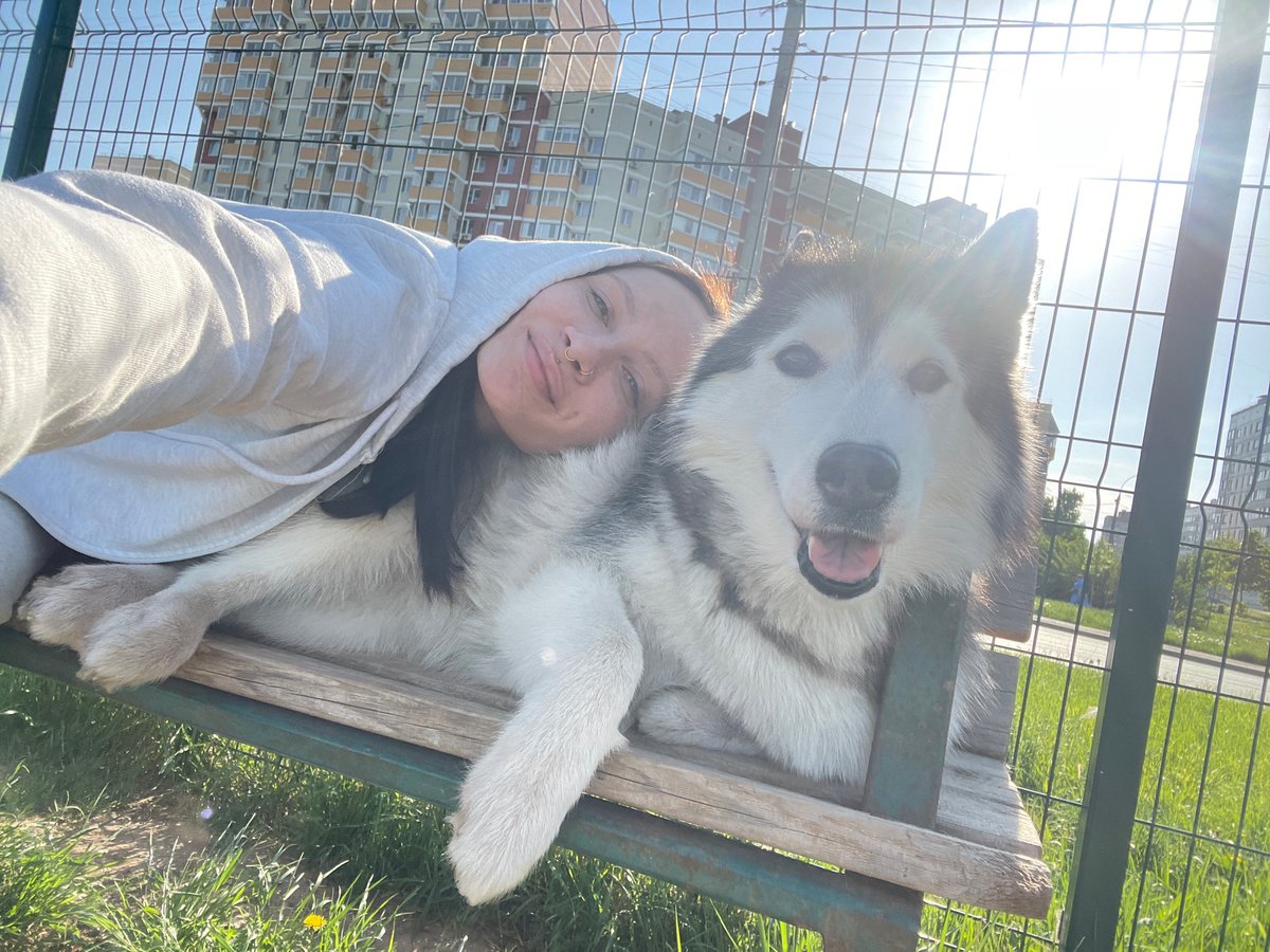 Woman and Husky enjoy afternoon park outing in Izhevsk