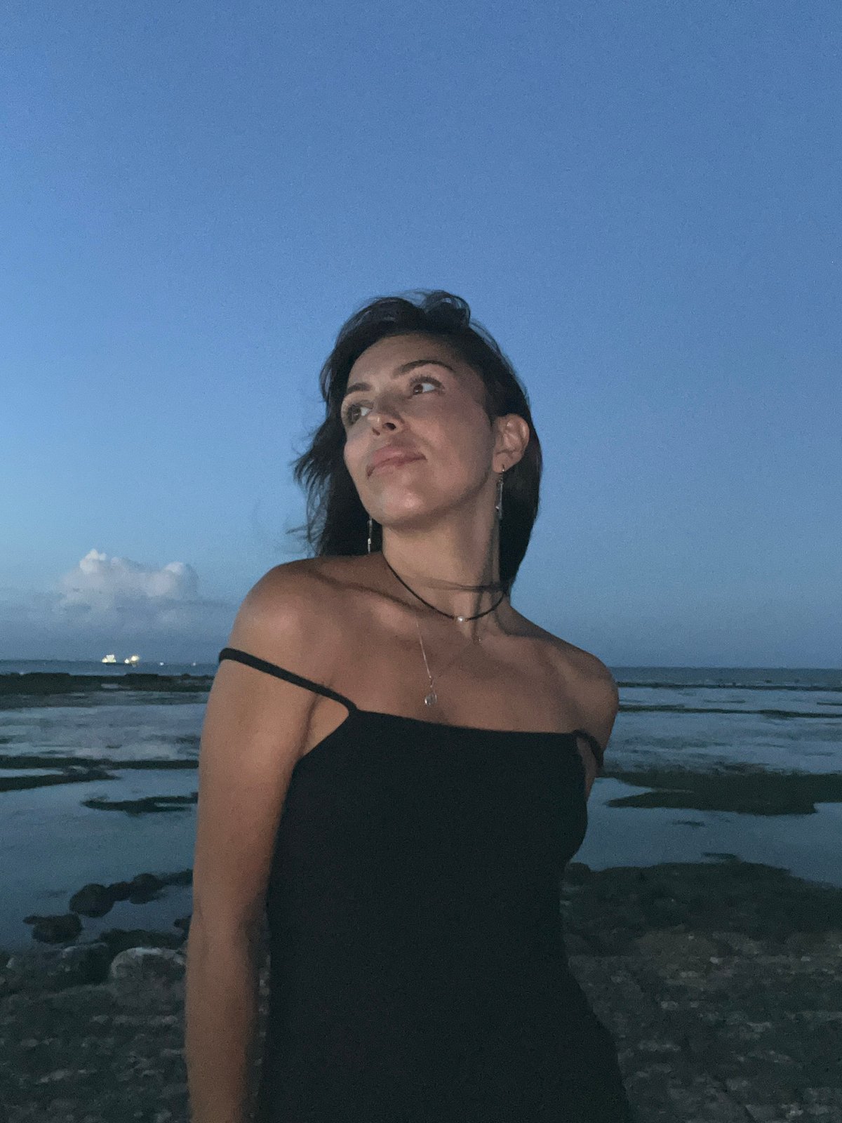 Woman poses for dusk photo session on Kuta coastline