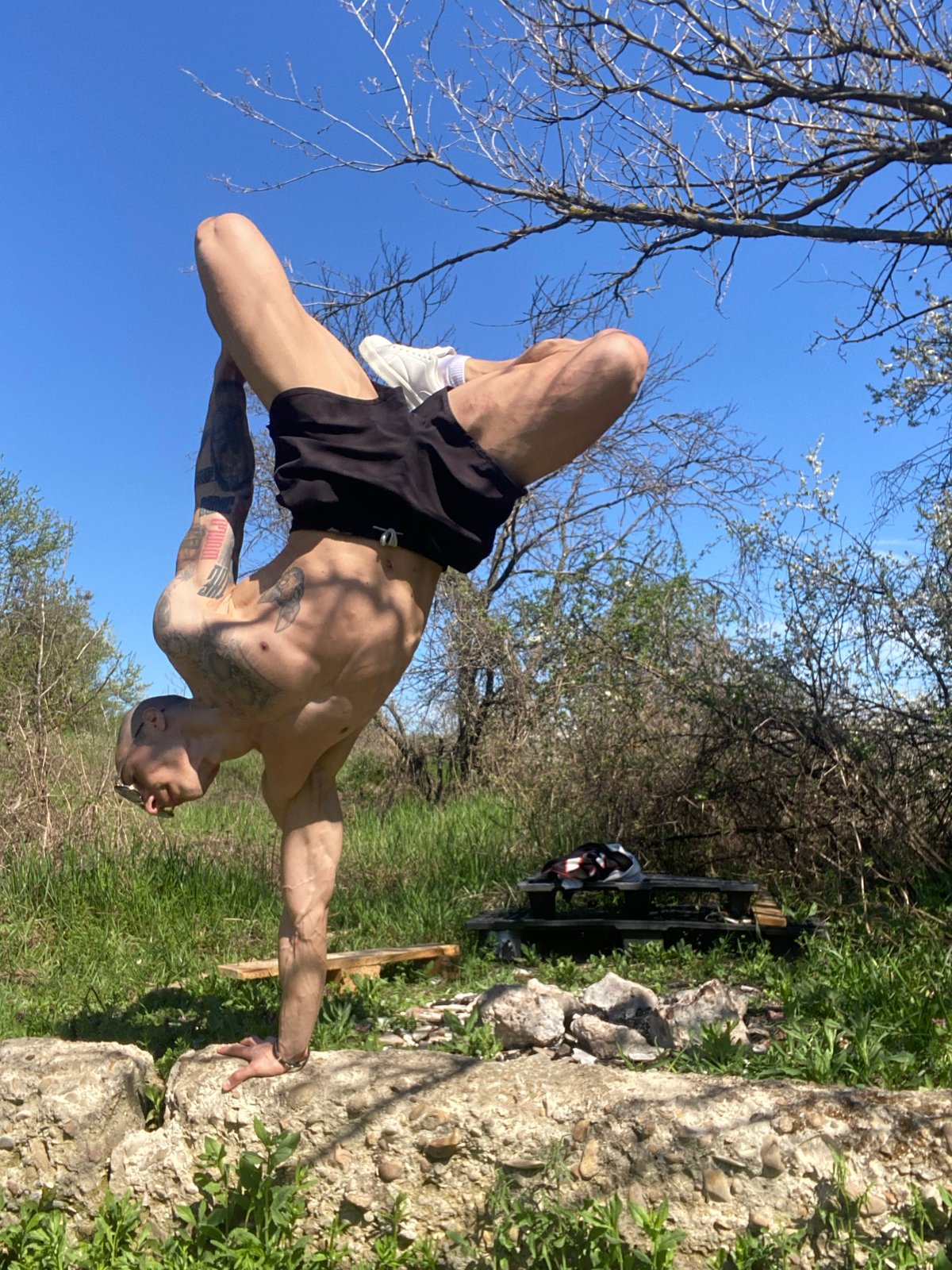 Tattooed man exercises outdoors in Pleven Bulgaria morning session