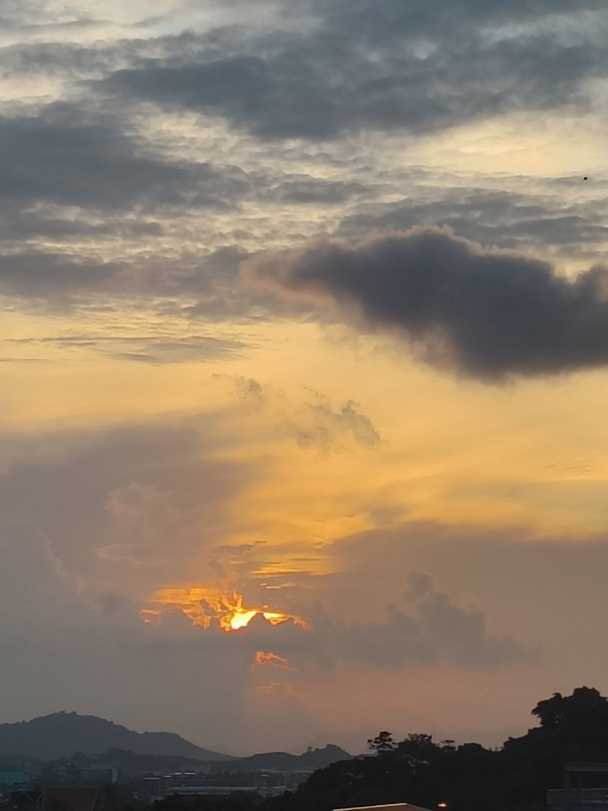City sunset with dramatic cloud colors across the skyline