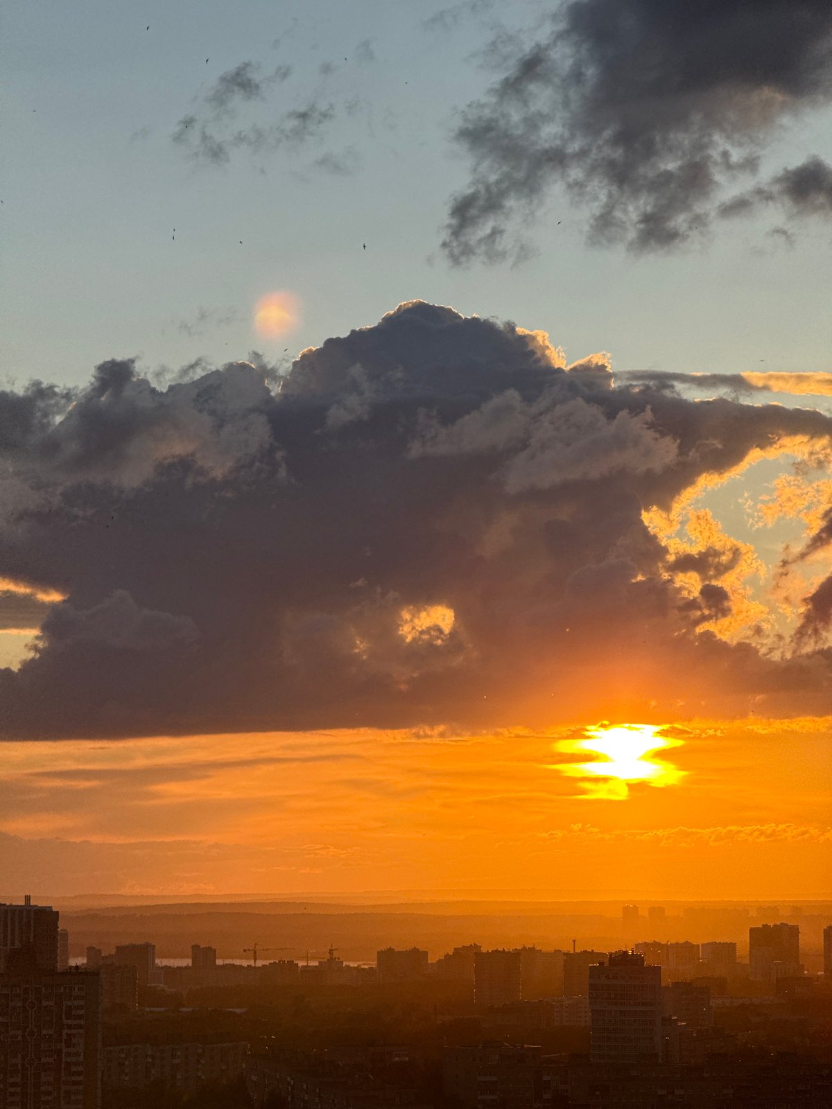 Dramatic sunset clouds over a Russian city skyline