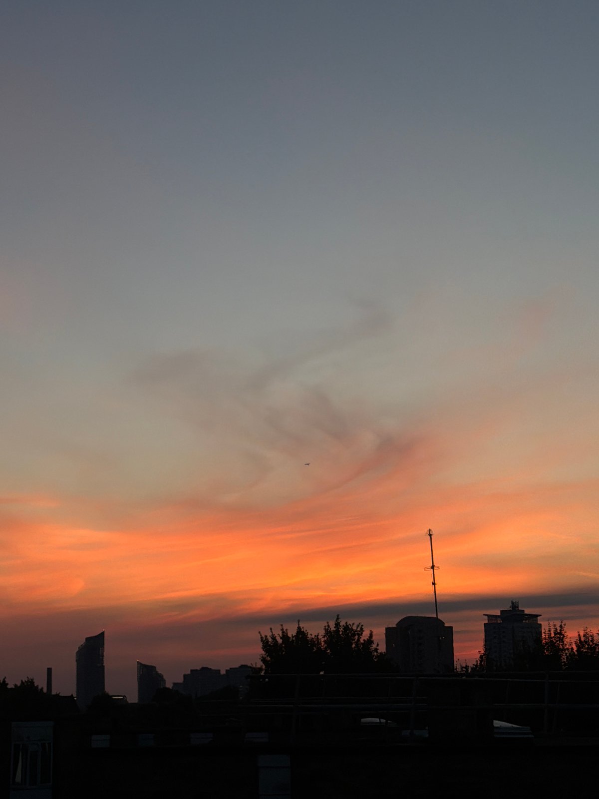 London solstice sunset watched from a city balcony
