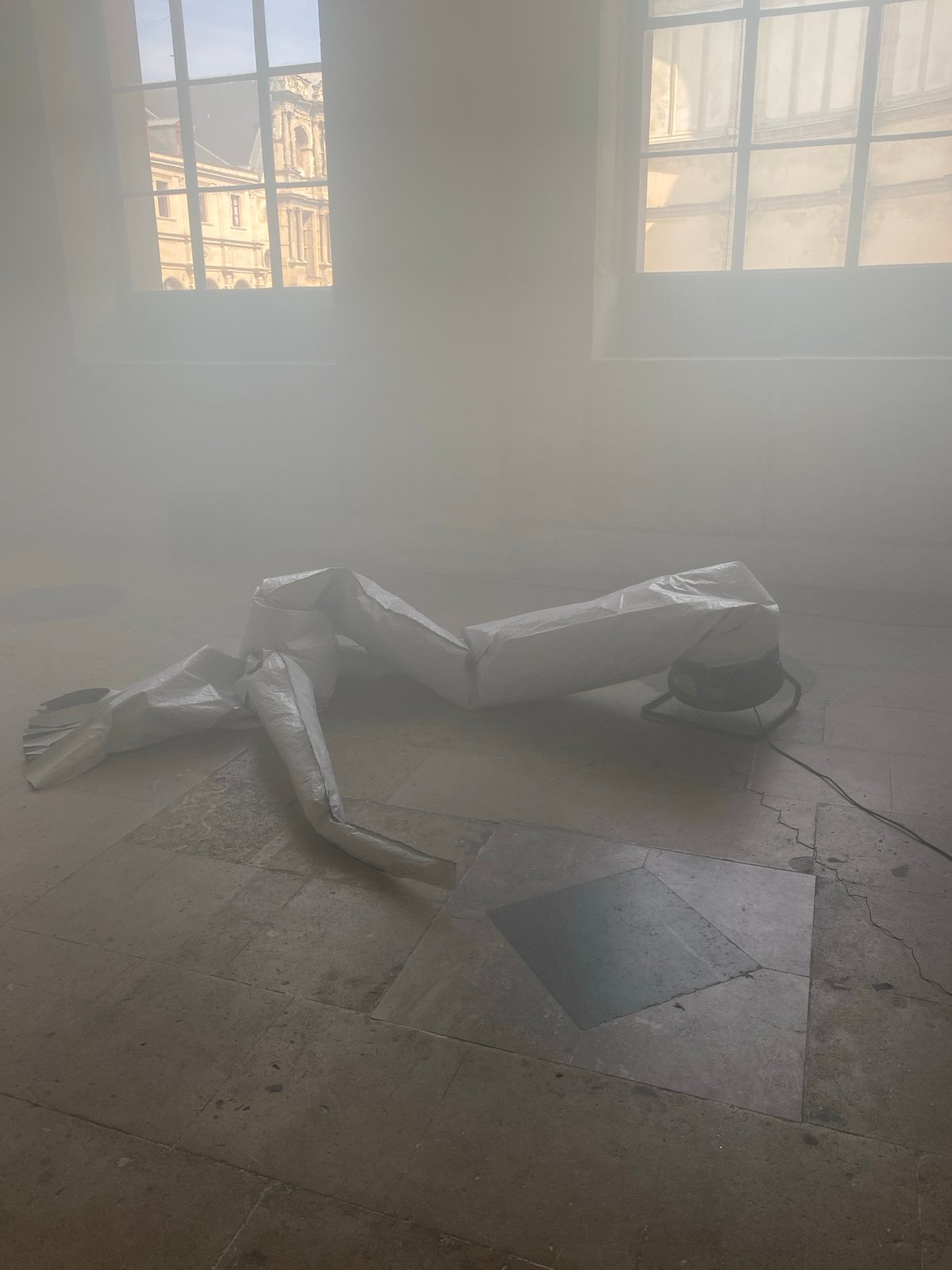 Smoke-filled Paris building interior with deflated inflatable documented